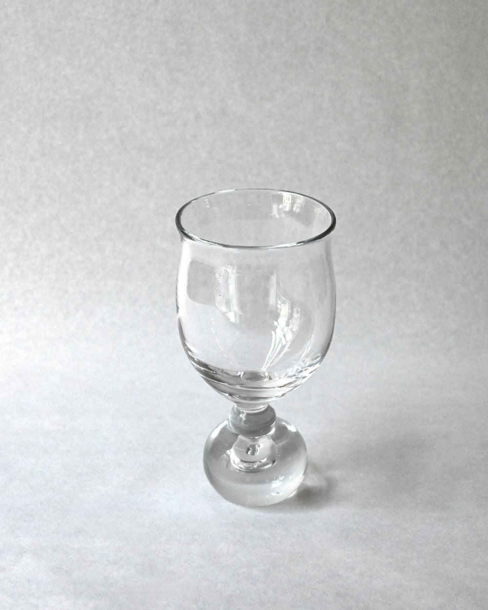 Clear glass goblet with rounded bowl and pedestal base from EDEN set