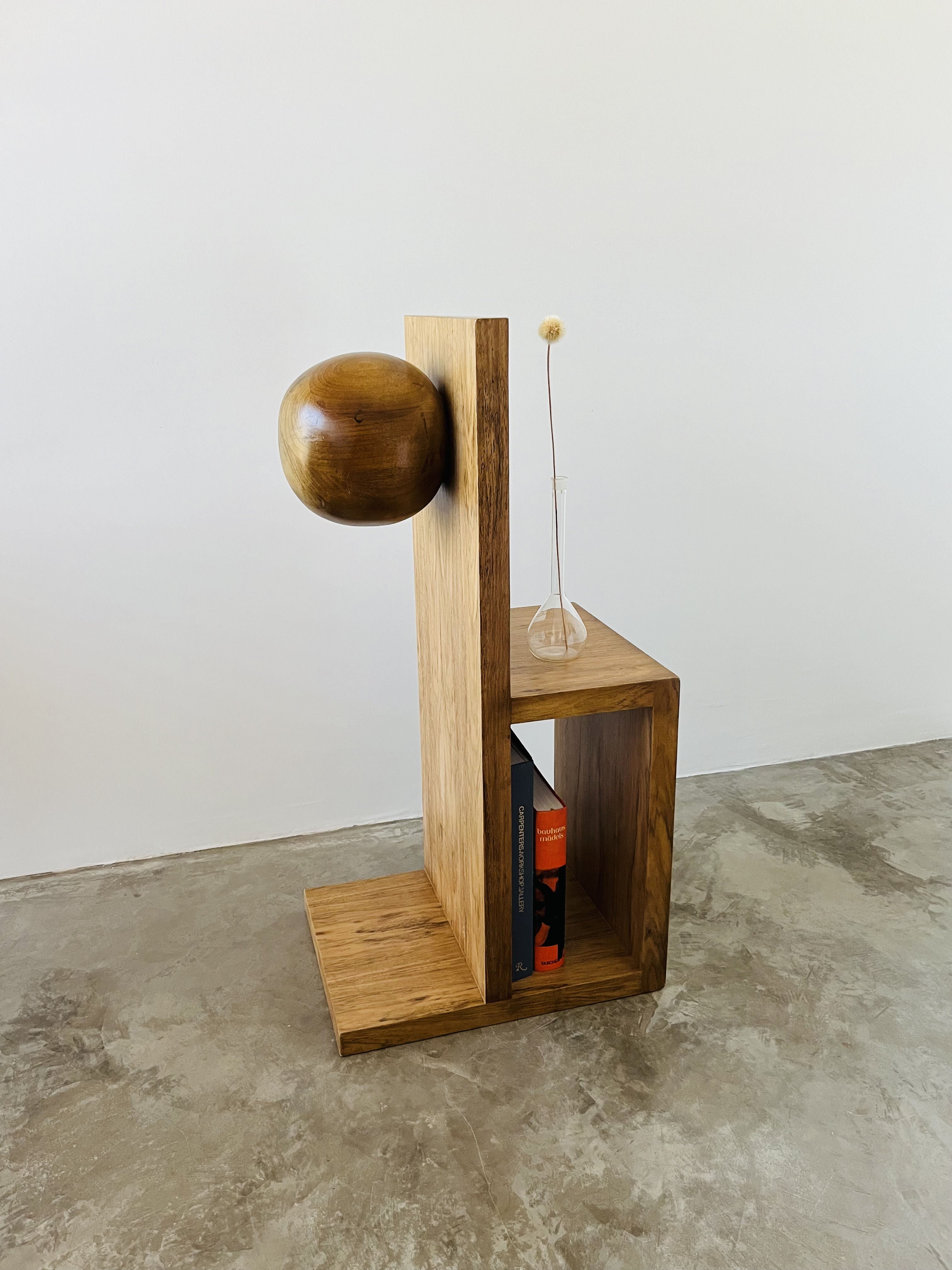 Lina Side Table — side angle showing natural wood finish and books