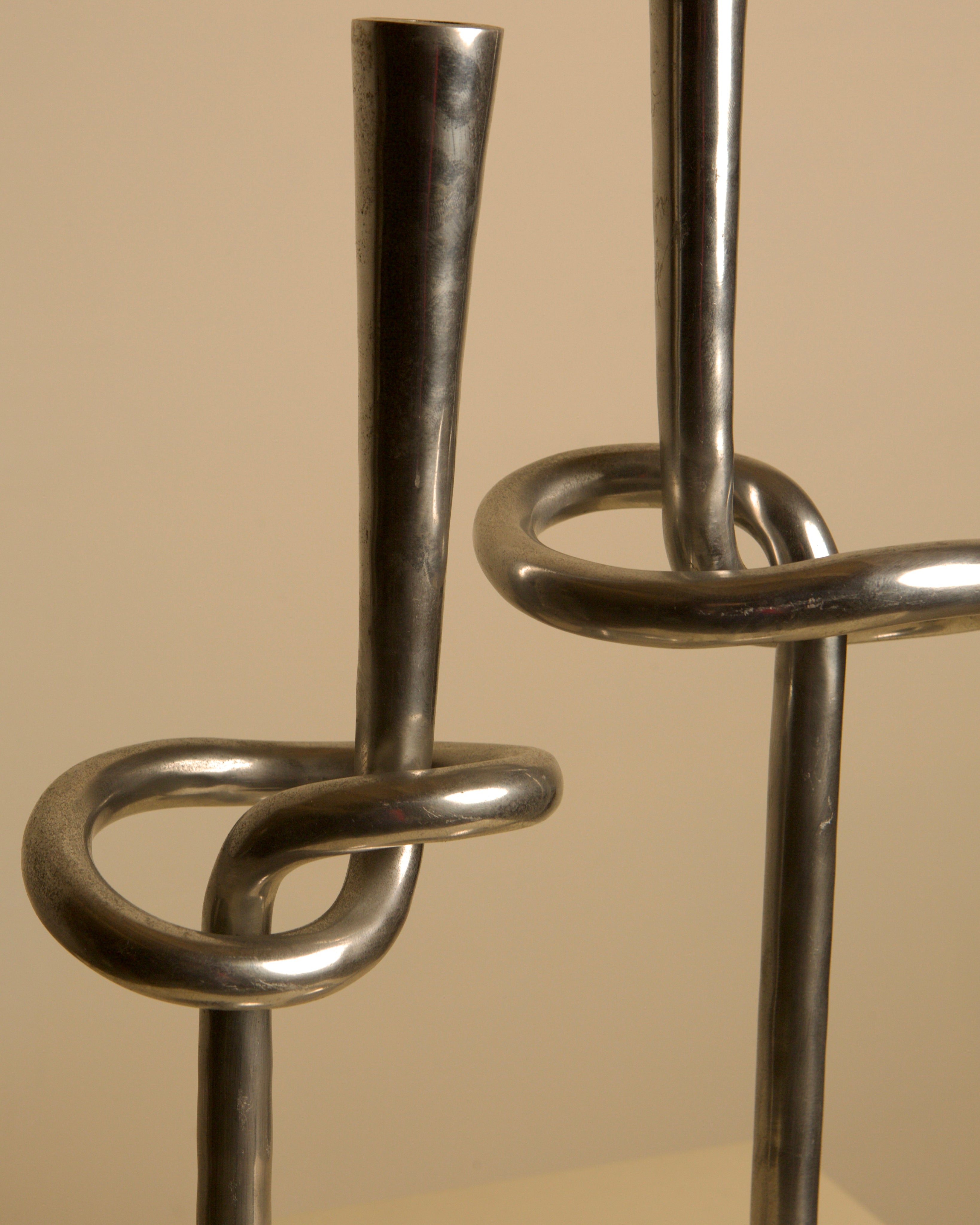 Pair of 80's Aluminum "Knot" Candleholders — close-up of shiny aluminum finish