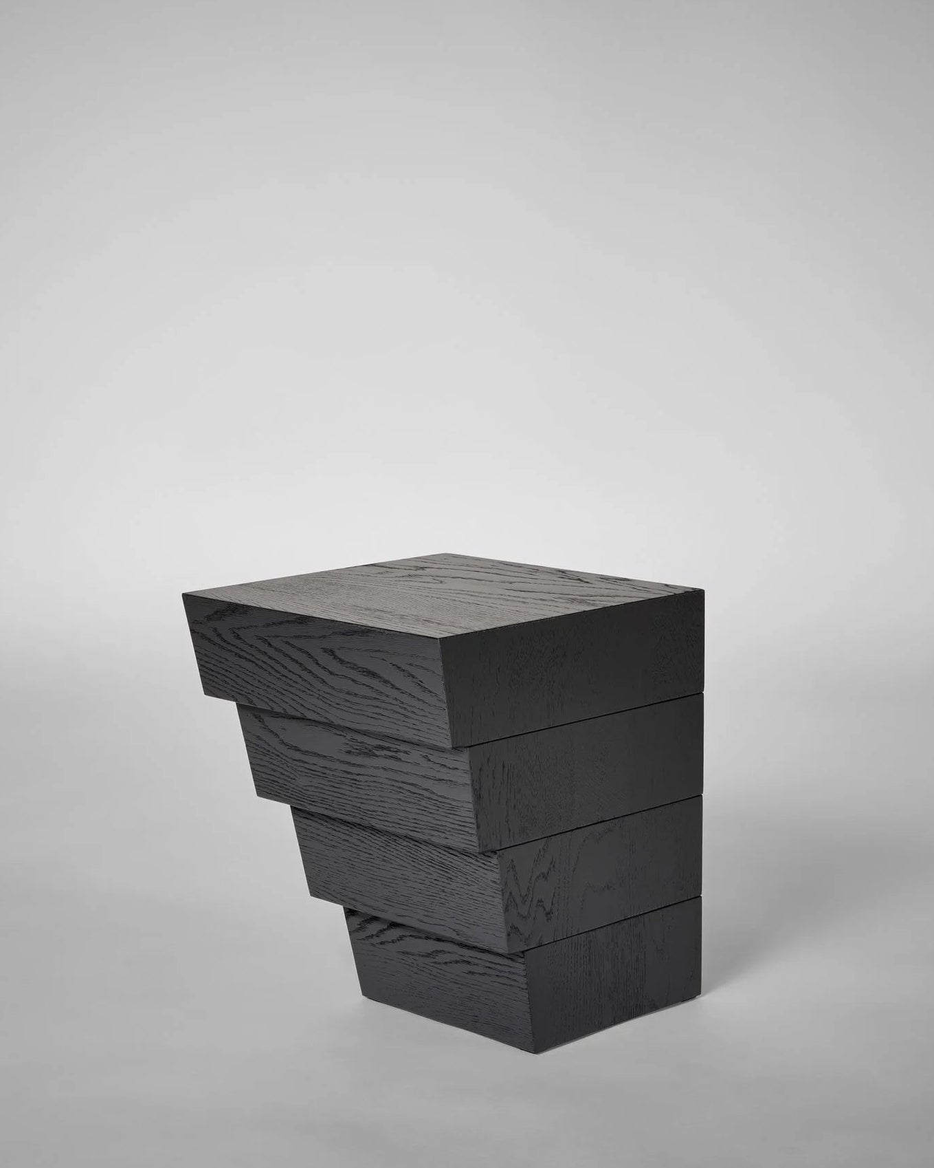 Taes Side Table — angled view of stacked black wood design
