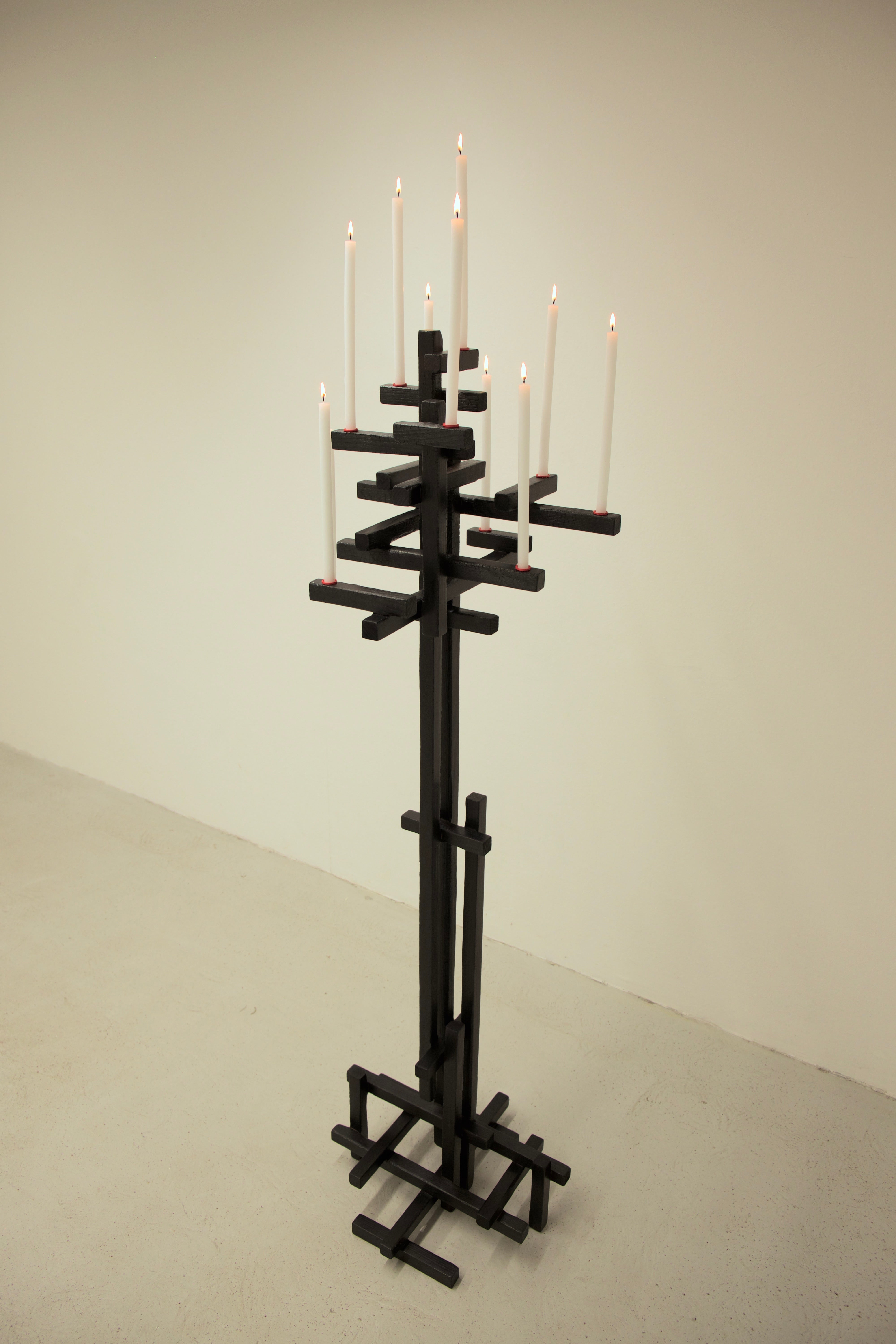 TETRIS CANDELABRUM — tall black candle holder with lit candles