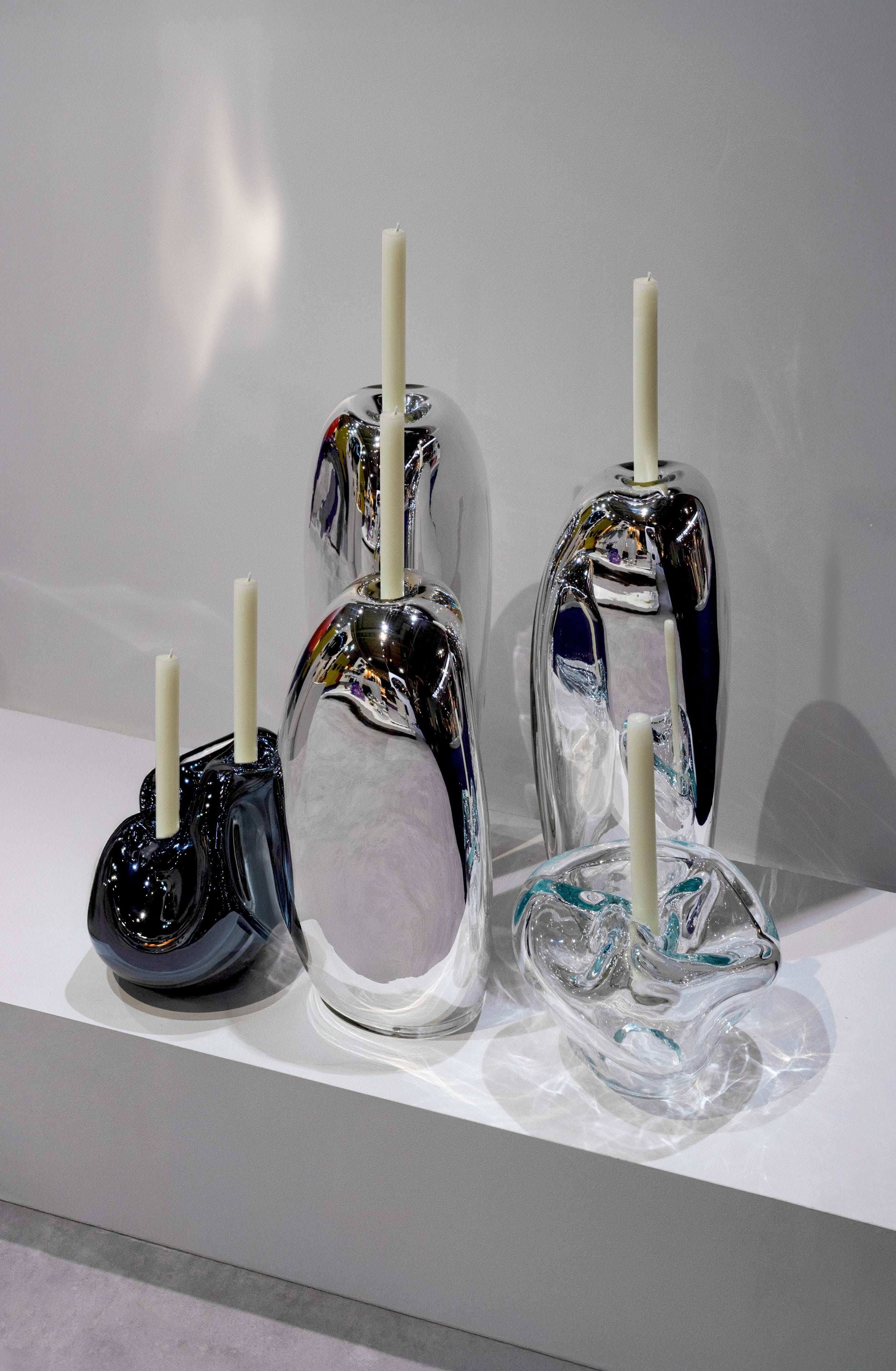 Lumos Candle Holders — arranged on white display with candles