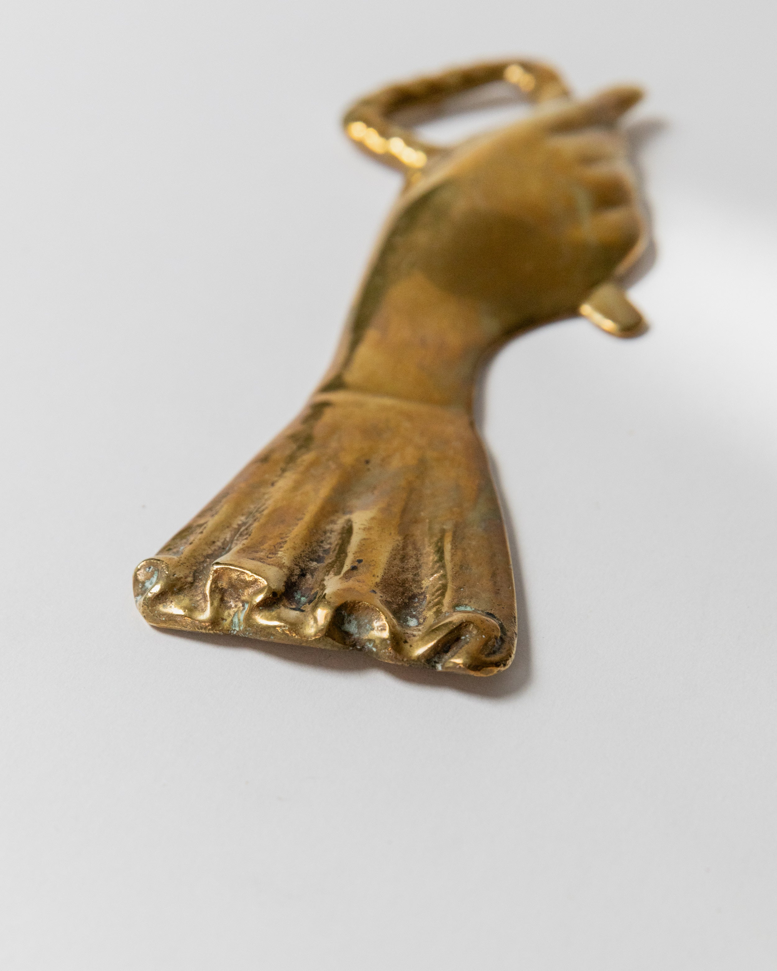 Brass bottle opener foot design detail showing toes and ankle from Italy 1950s