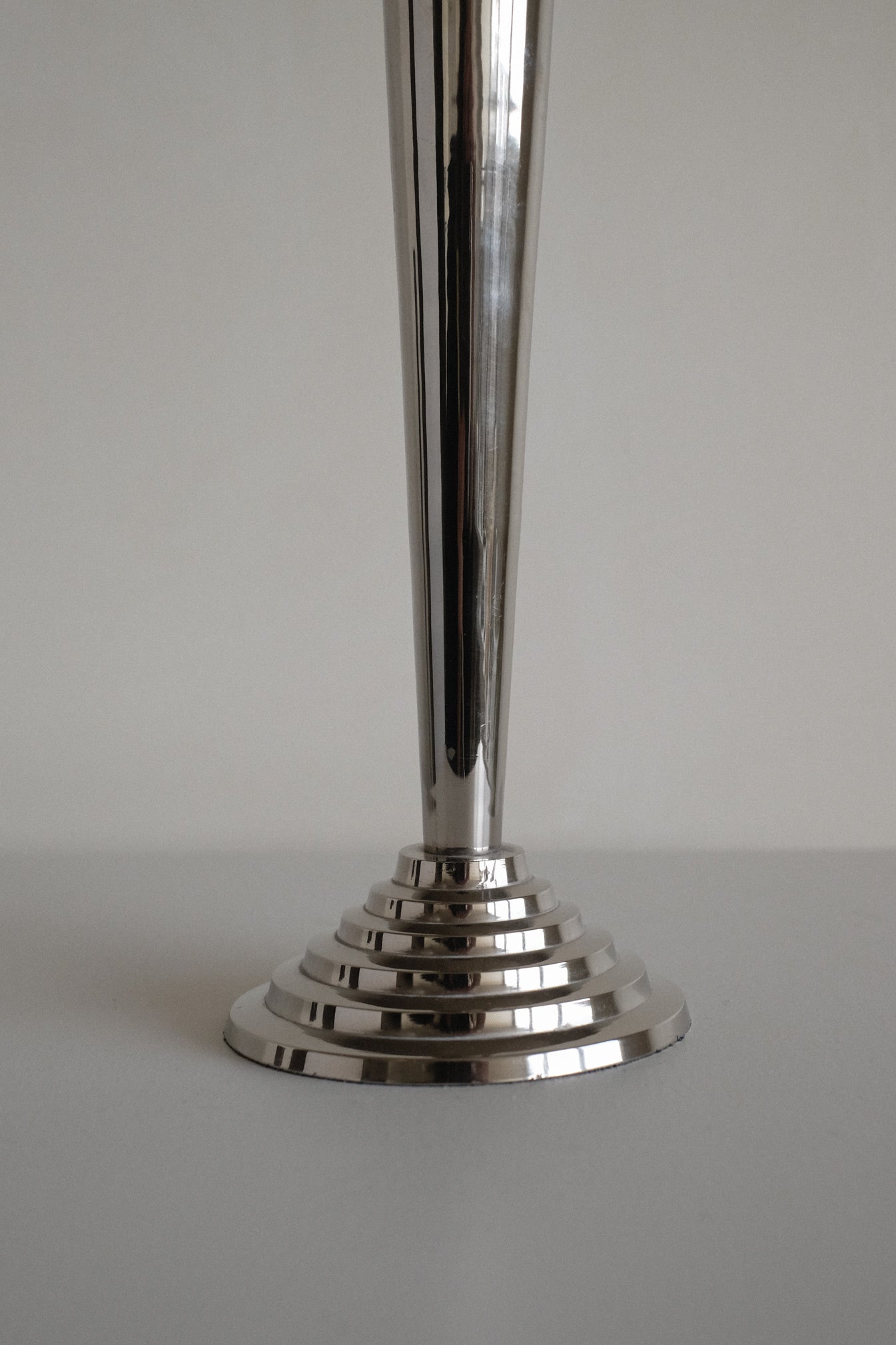 Art Deco Candle Holders — close-up of polished metal base