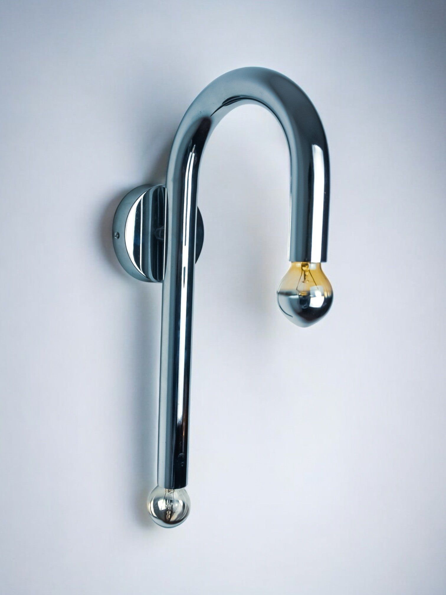 Space-age tubular wall lamp, chromed metal, Italy, 1970 — lifestyle setting