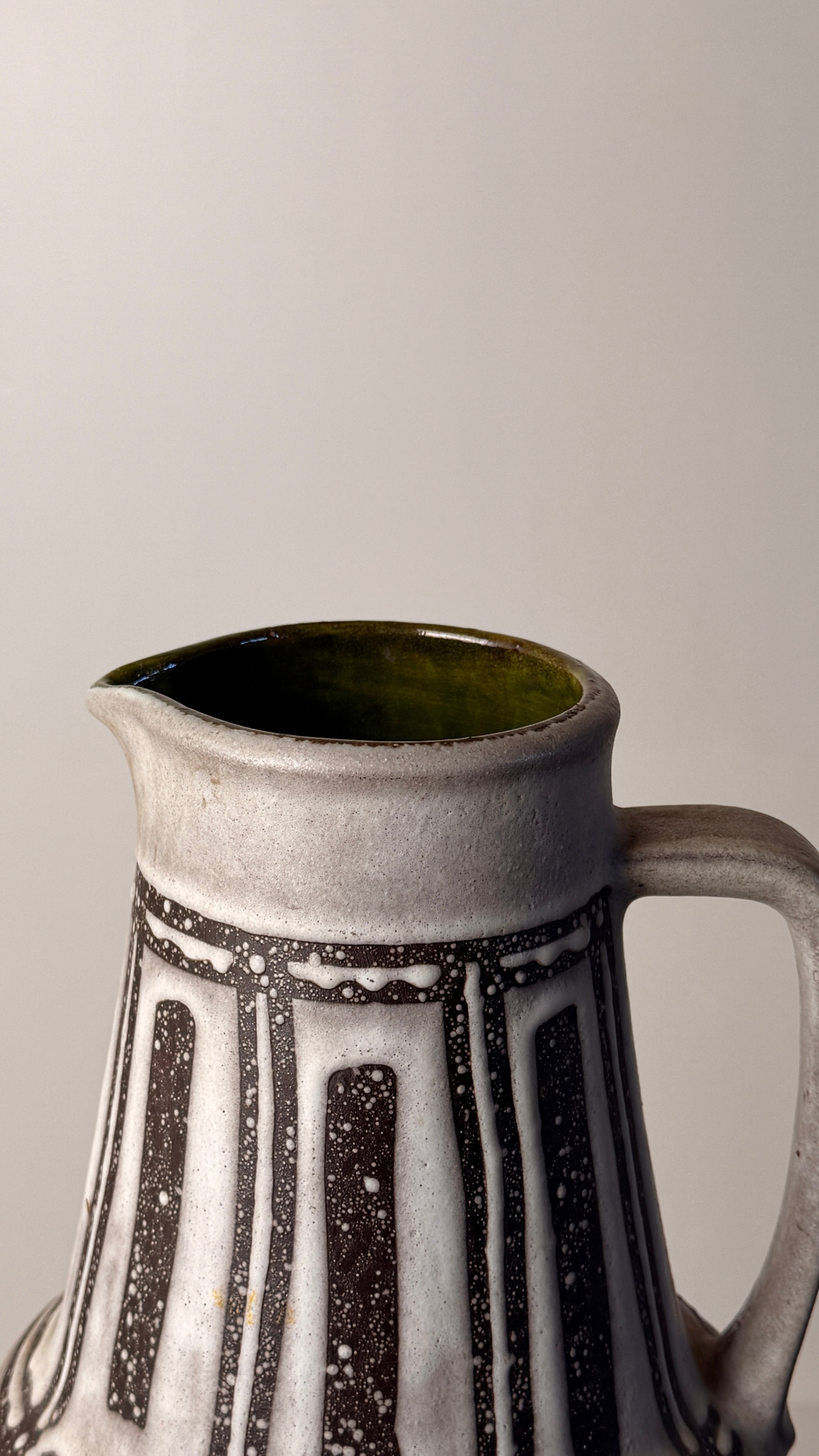 Ceramic pitcher, Germany, circa 1960. — top view highlighting textured gray surface
