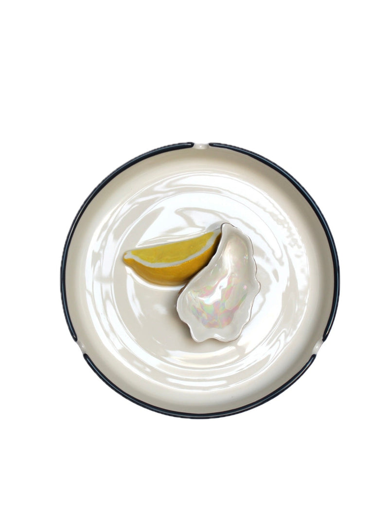 PLAISIR SOLITAIRE ceramic ashtray — top view with lemon and shell detail