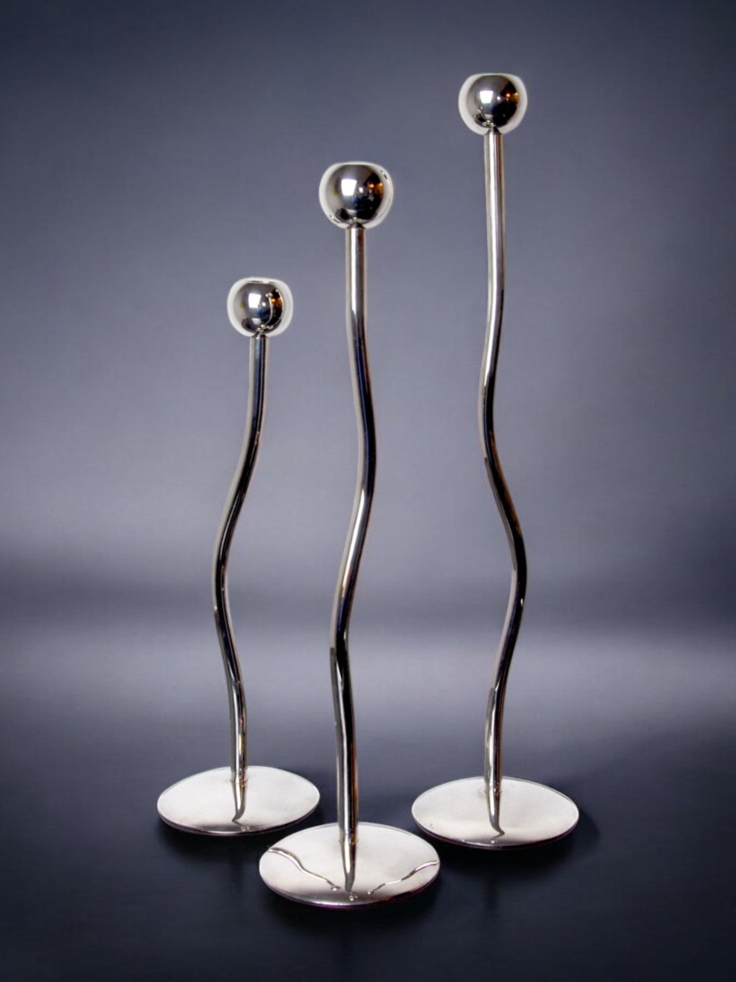 Trio of silver metal candlesticks from mesa italy, italy, 1980s — side angle
