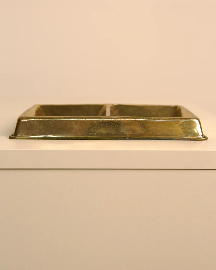 Vintage brass two-compartment vide-poche tray on white shelf