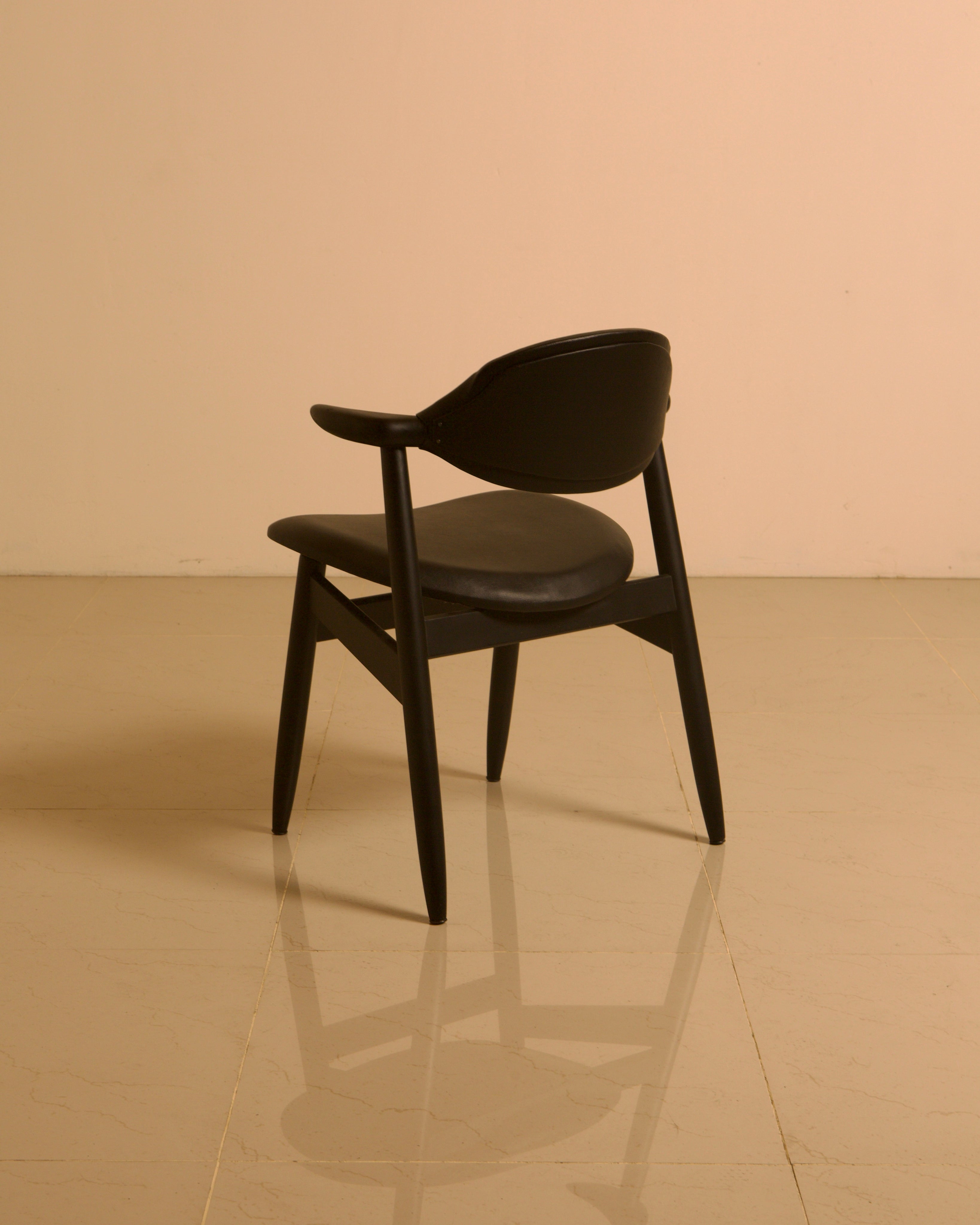 Dutch "Buffalo" Armchair in Wood and Black leather, 1960s — angled view highlighting black leather seat and wooden legs