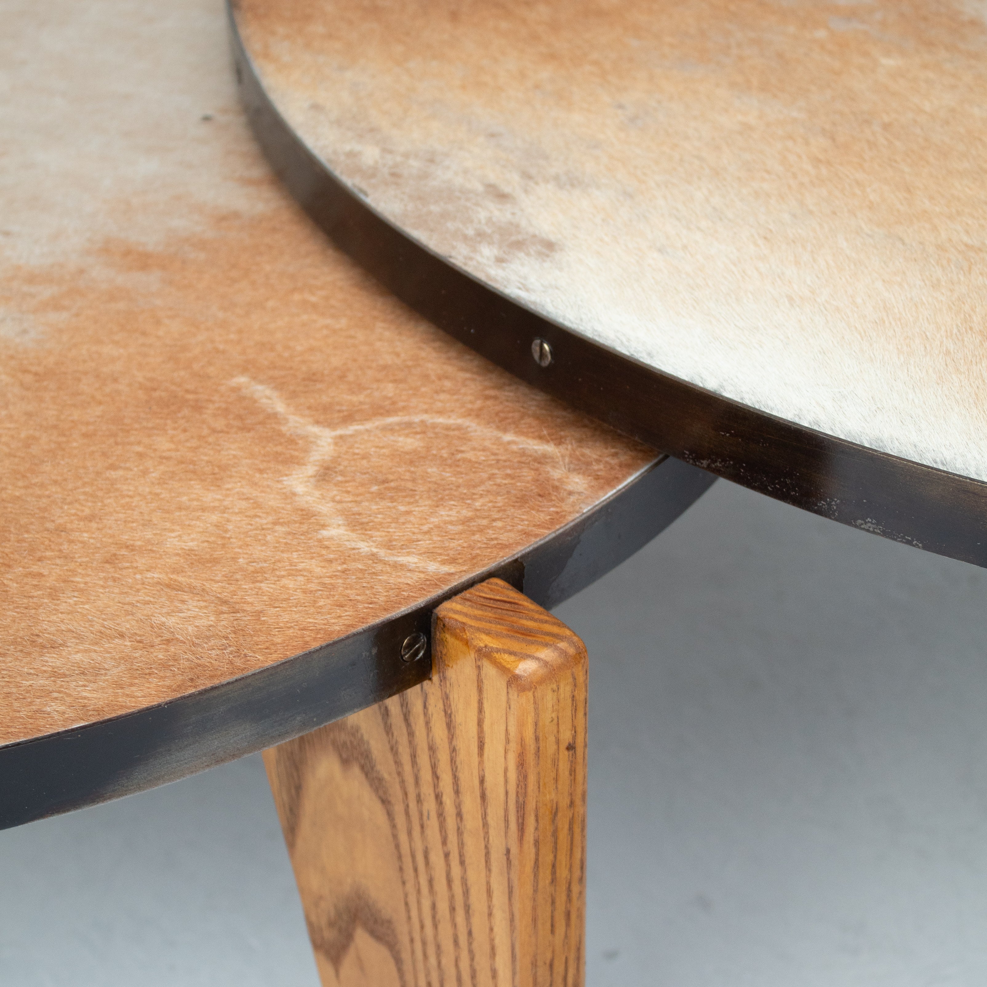 2 Coffee Tables in Wood and Cowhide — top view showing cowhide surface and wooden legs