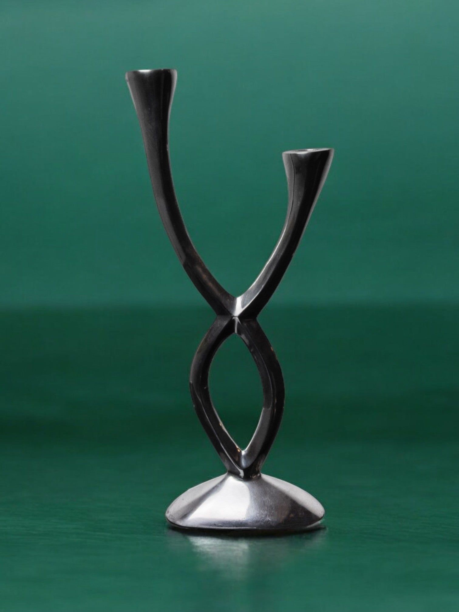 Candleholder by Matthew Hilton, England, 1980s — side angle showing polished metal finish