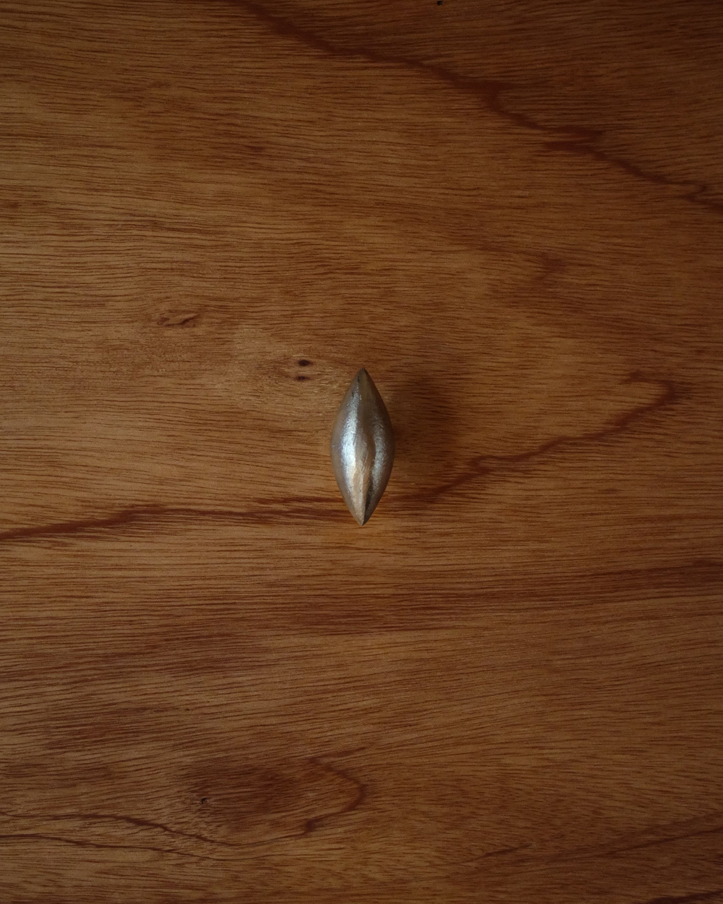 GOOD EYE Cabinet Knob/Wall Hook — top view on wooden surface
