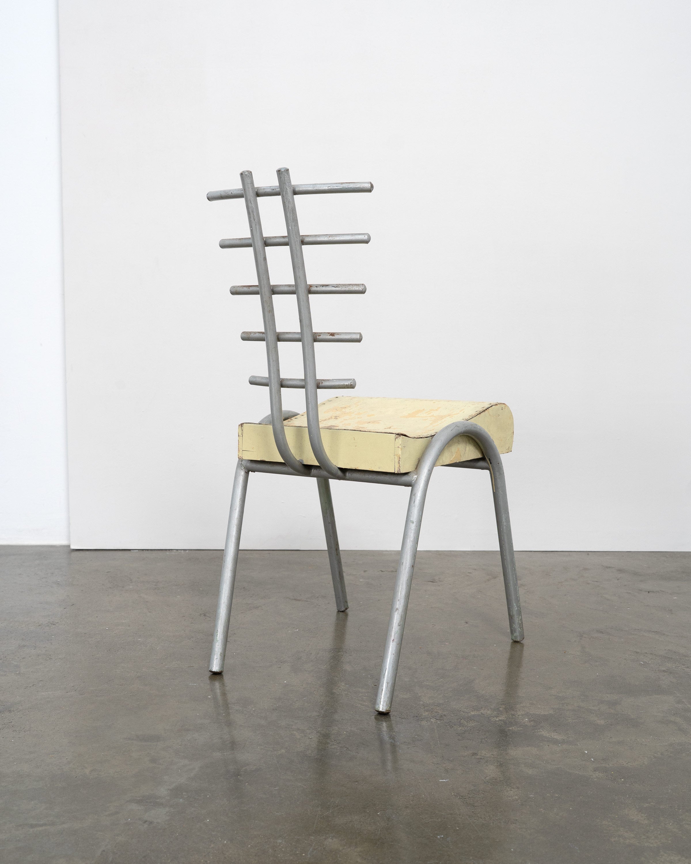Postmodern prototype chair with yellow foam seat and steel frame