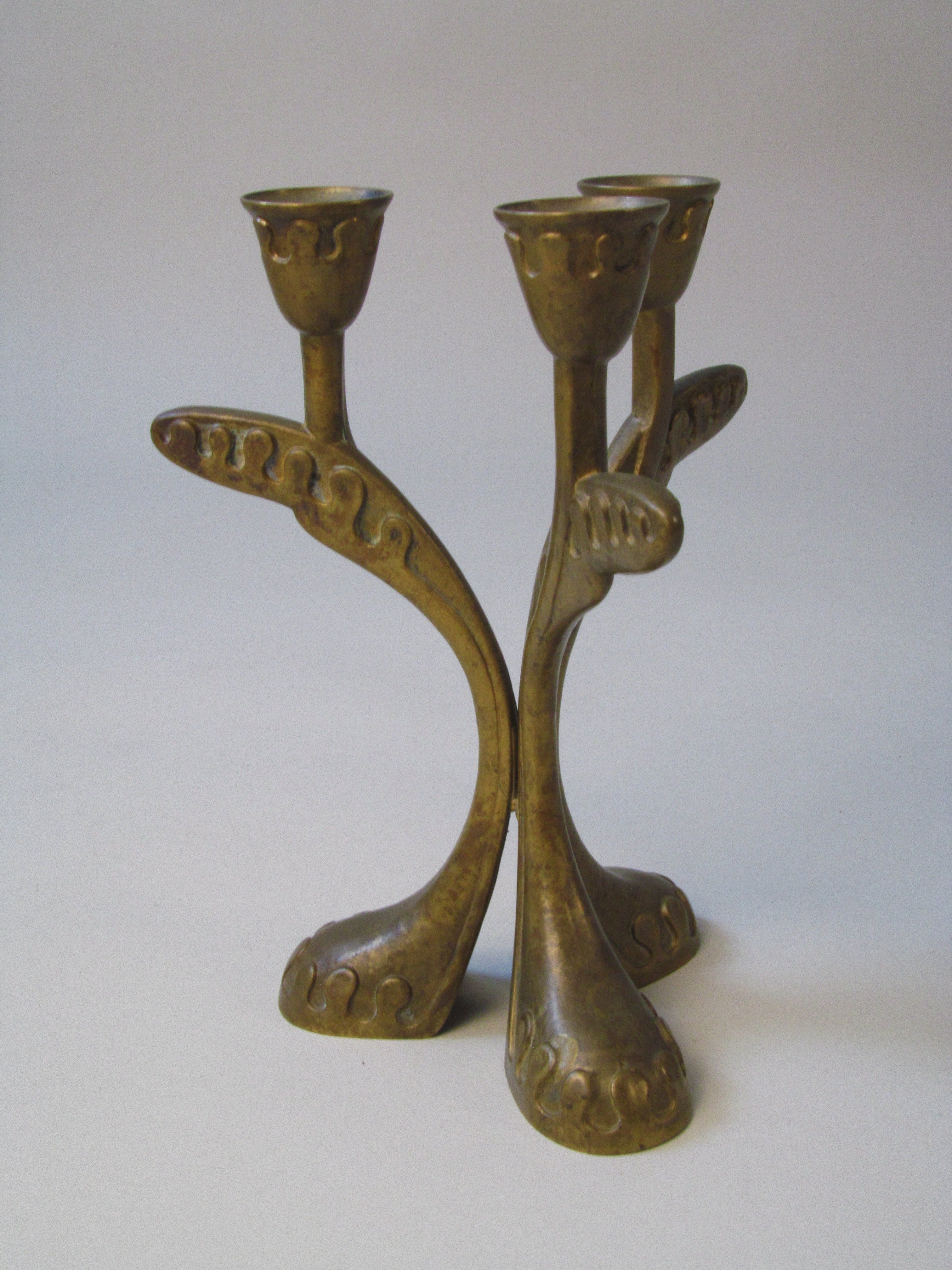 Brass Three Arm Candelabra — close-up of curved brass arms