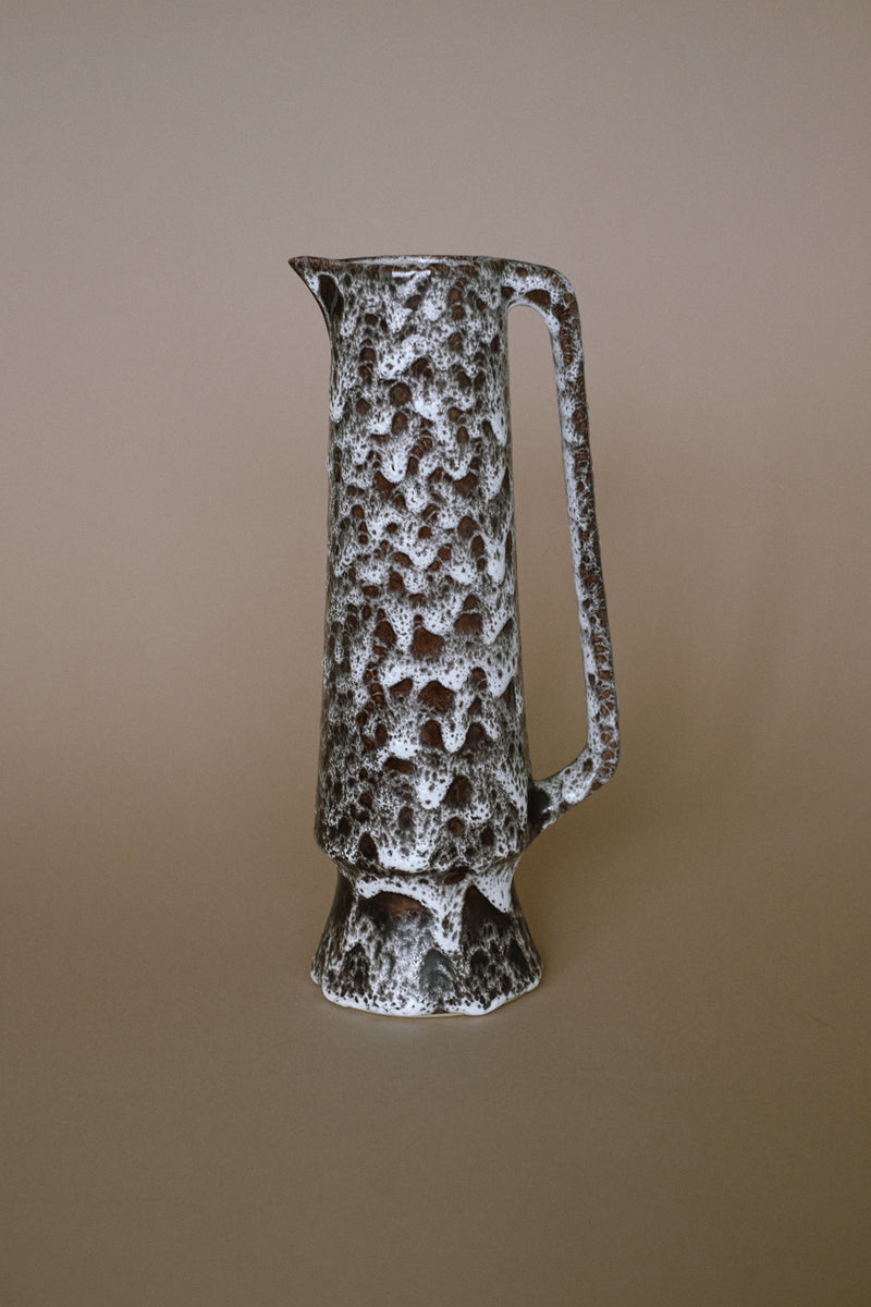 Textured stoneware pitcher with speckled brown and white glaze