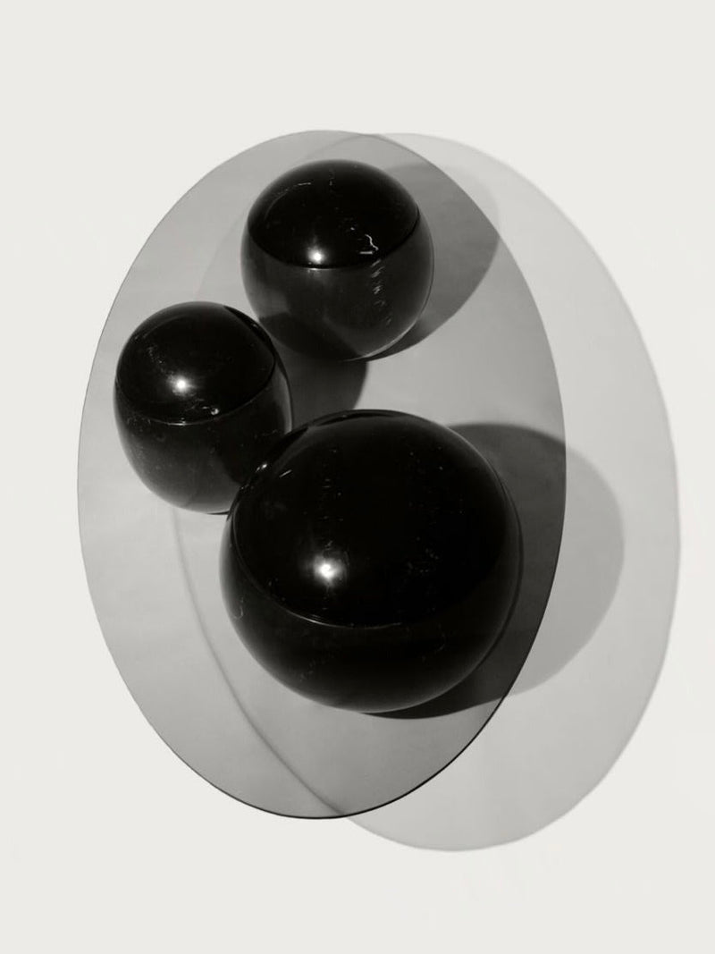 Ovni Uovo' Coffee Table — close-up of glossy black spheres on surface