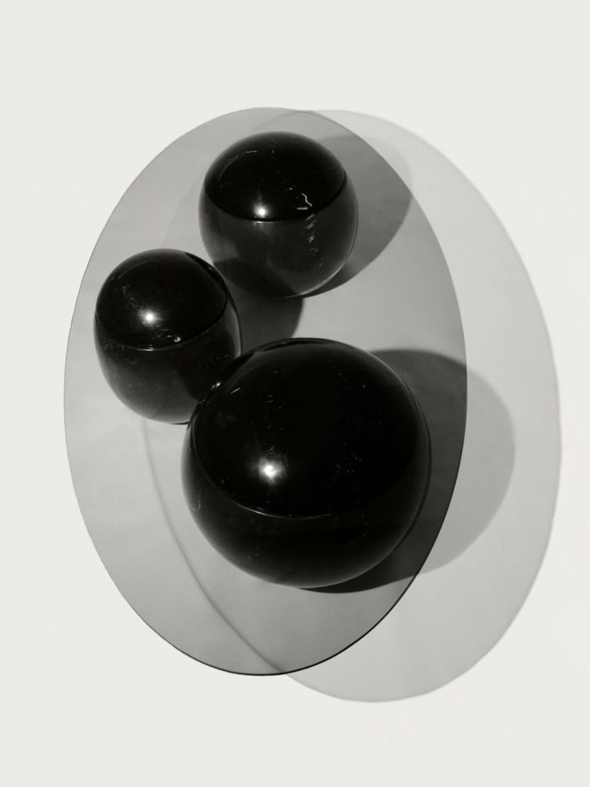 Ovni Uovo' Coffee Table — close-up of glossy black spheres on surface