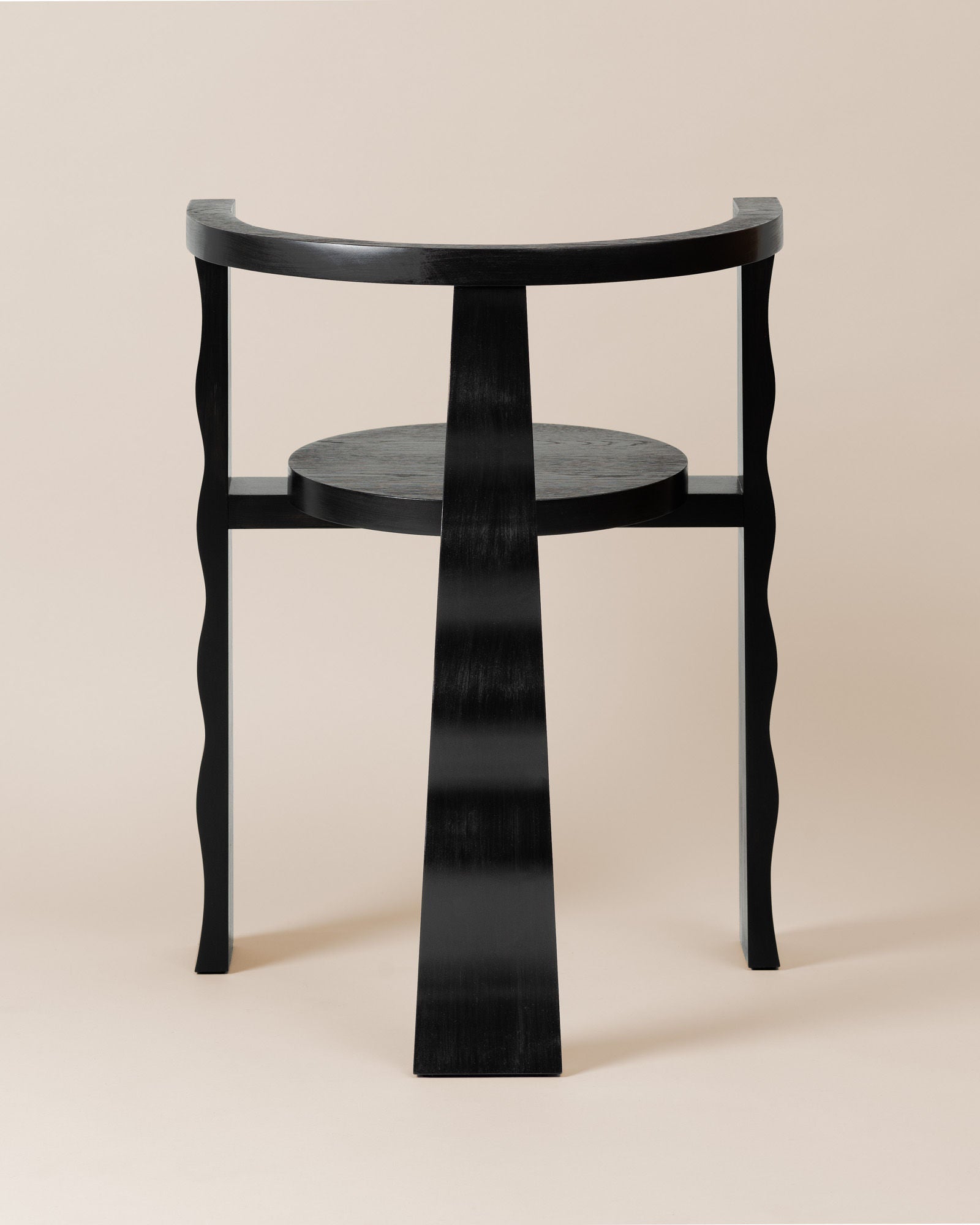 Black wooden Puro chair with curved legs and circular shelf detail