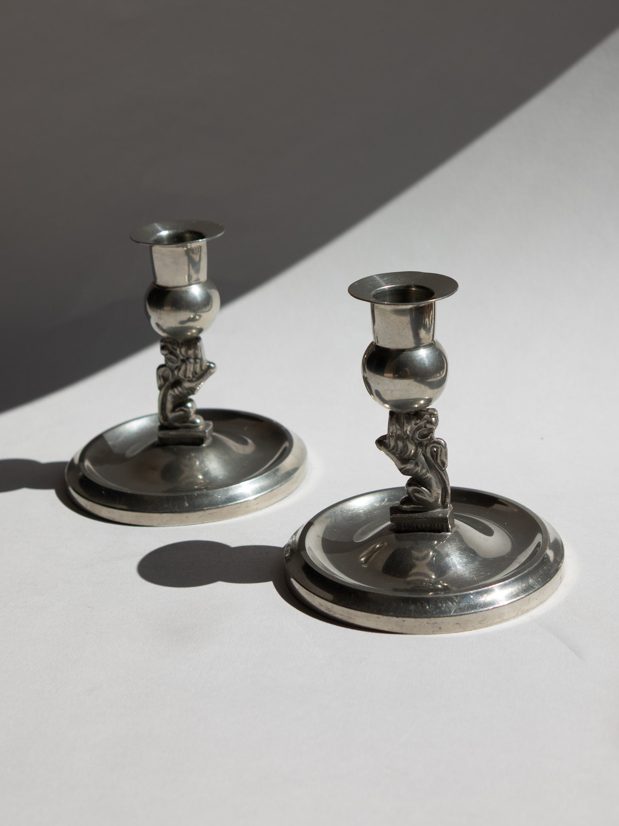 Pair of Swedish Grace Art Deco Pewter Lion Candlesticks by Eskilstuna Metallindustri, 1932 by Trove Paris