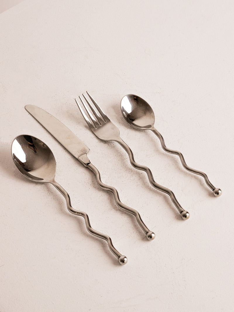 16 piece Wavy 80s Cutlery in Stainless Steel — close-up of wavy handles on utensils