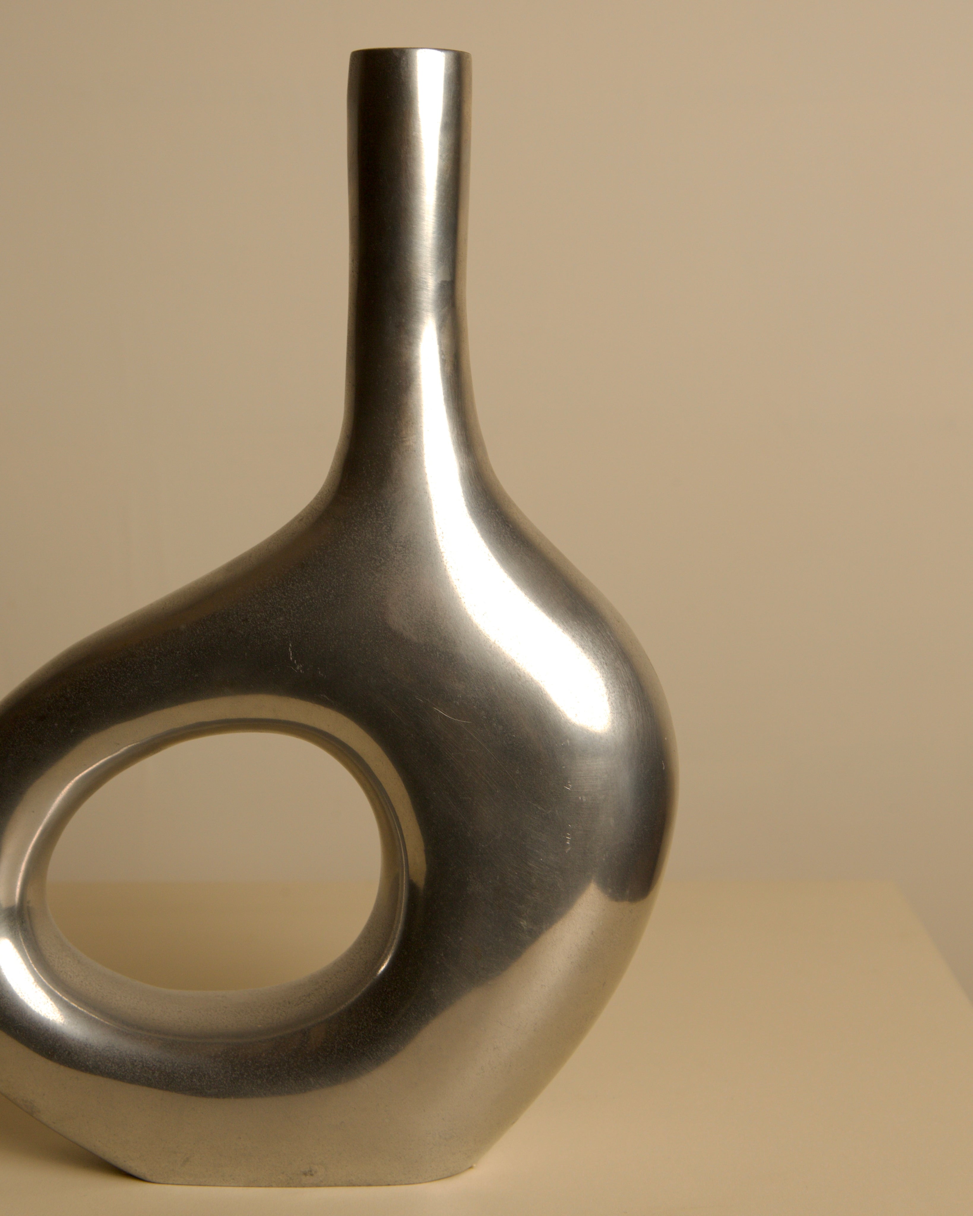 Italian Cast Aluminum Vase 80's — side angle highlighting smooth metallic finish