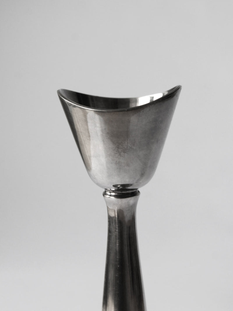 Close-up detail of silver-plated candlestick cup and stem junction