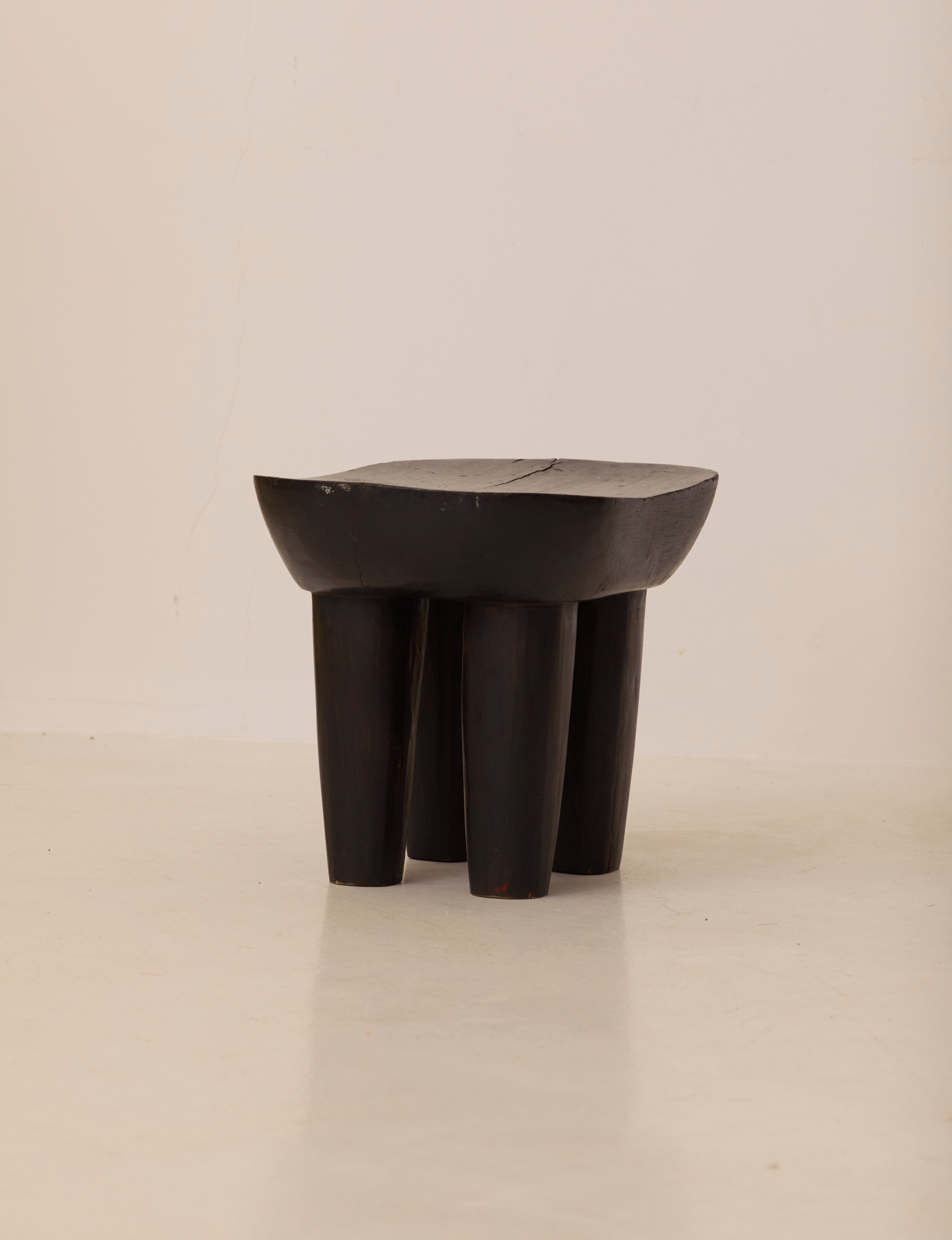 Vintage Senufo Monoxyl African Stool in Black / Wenge — angled view highlighting sturdy wooden legs