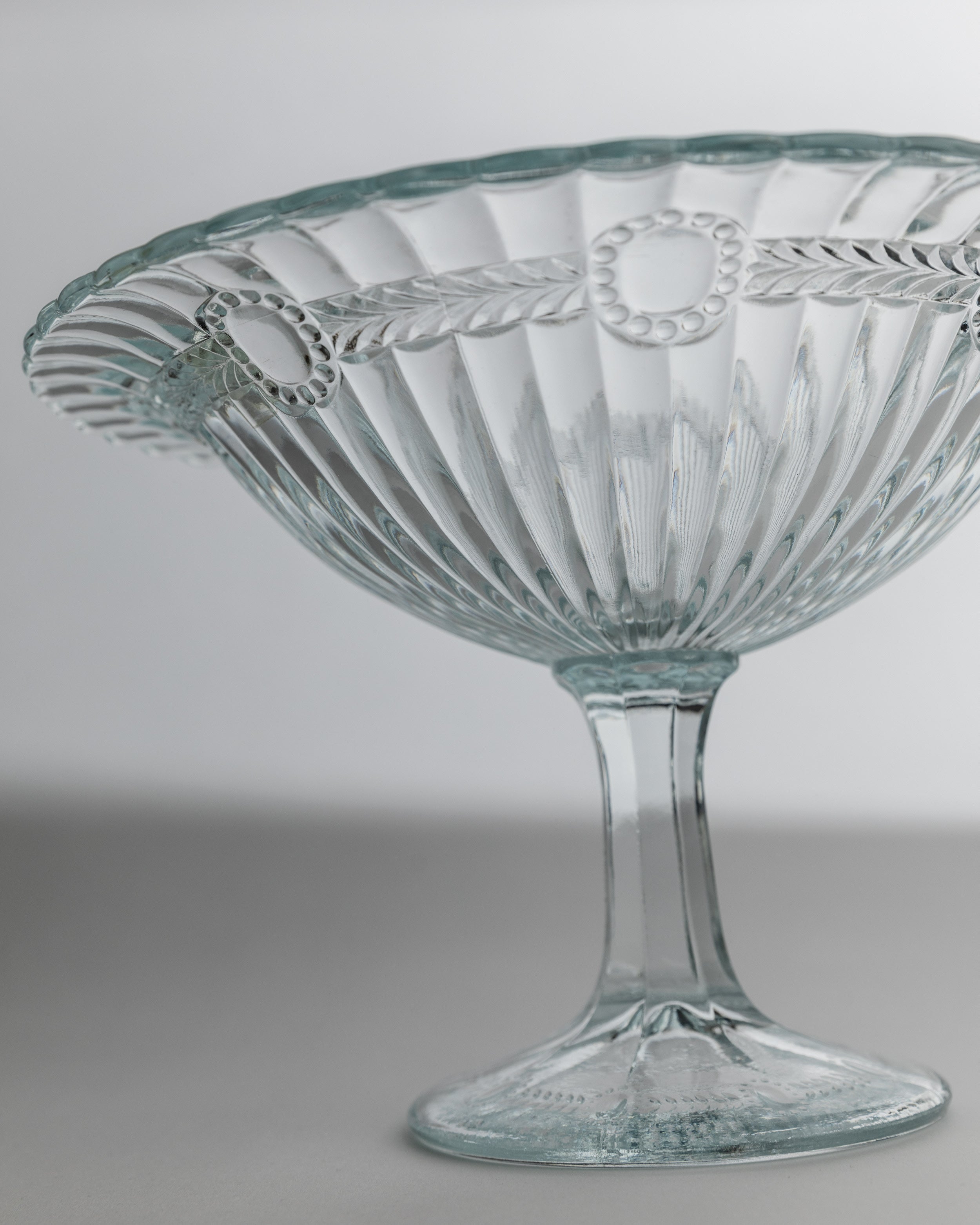 Ribbed glass serving bowl on pedestal base detail view