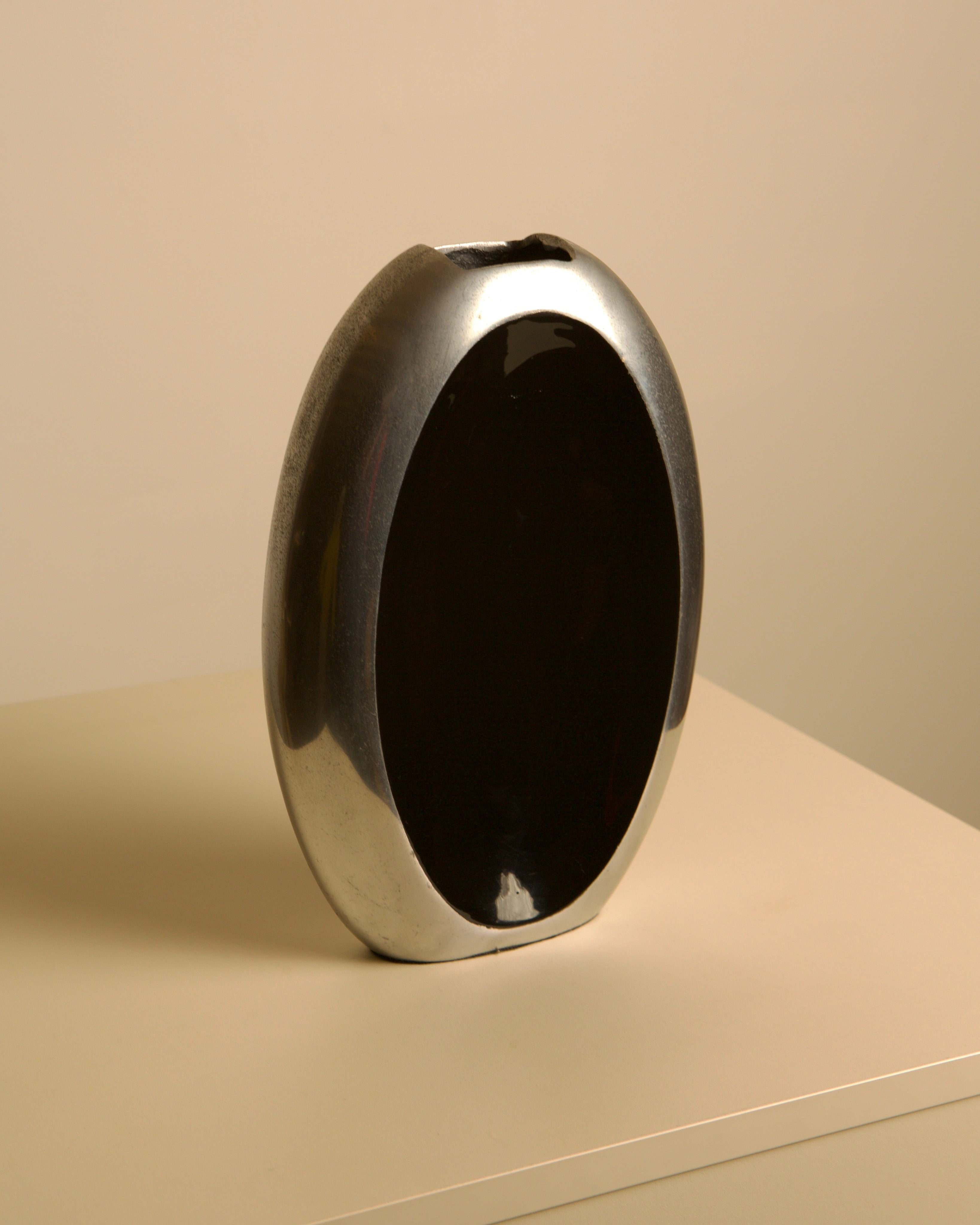 Italian Vase in Aluminum and Black Enamel, 80s — side angle on neutral background