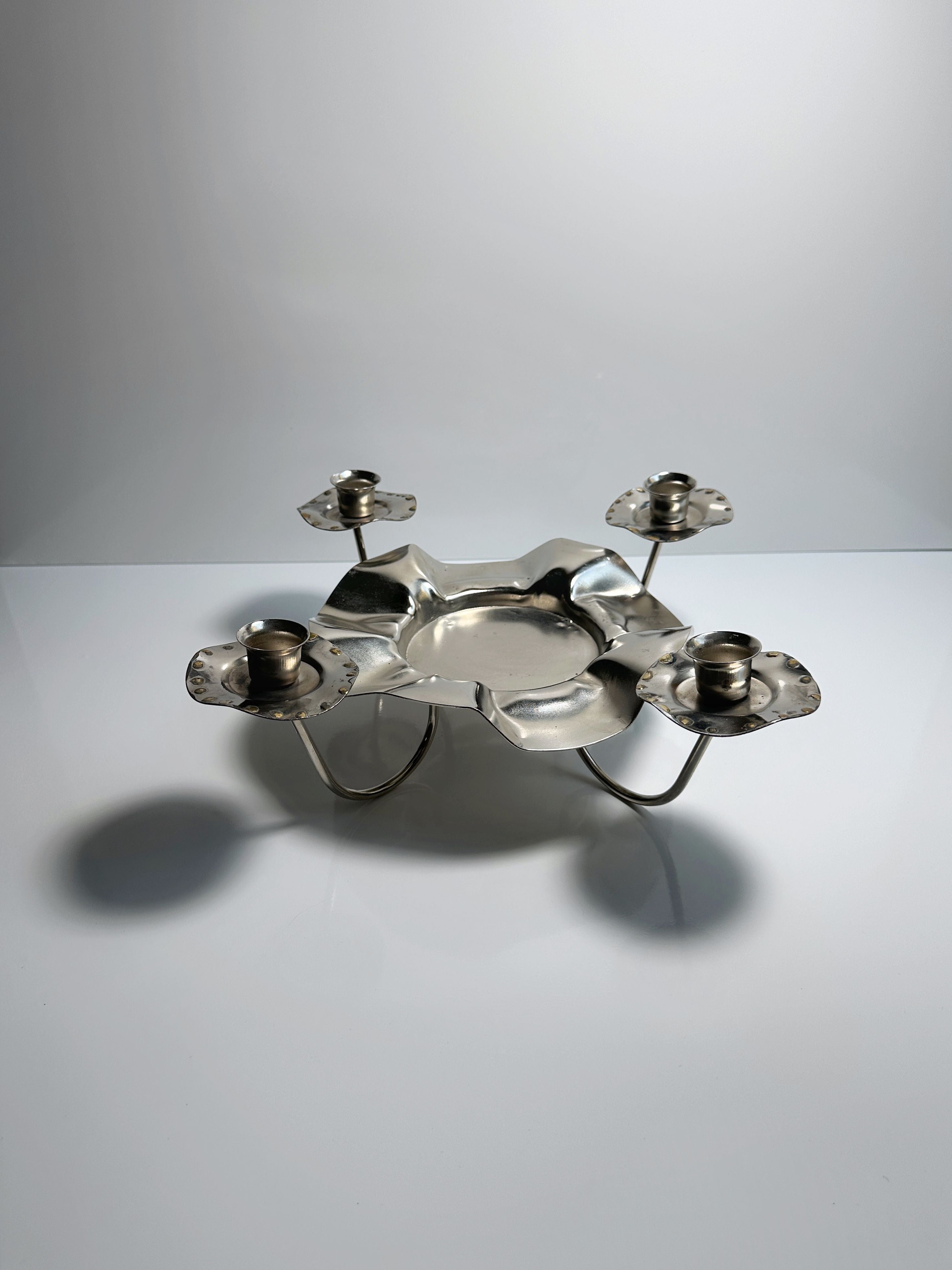 Silver Metal 1960s Candleholder — side angle on reflective surface