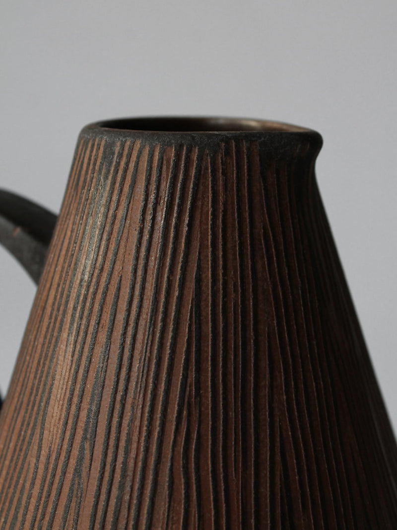 Textured ceramic jug detail showing vertical ridged pattern