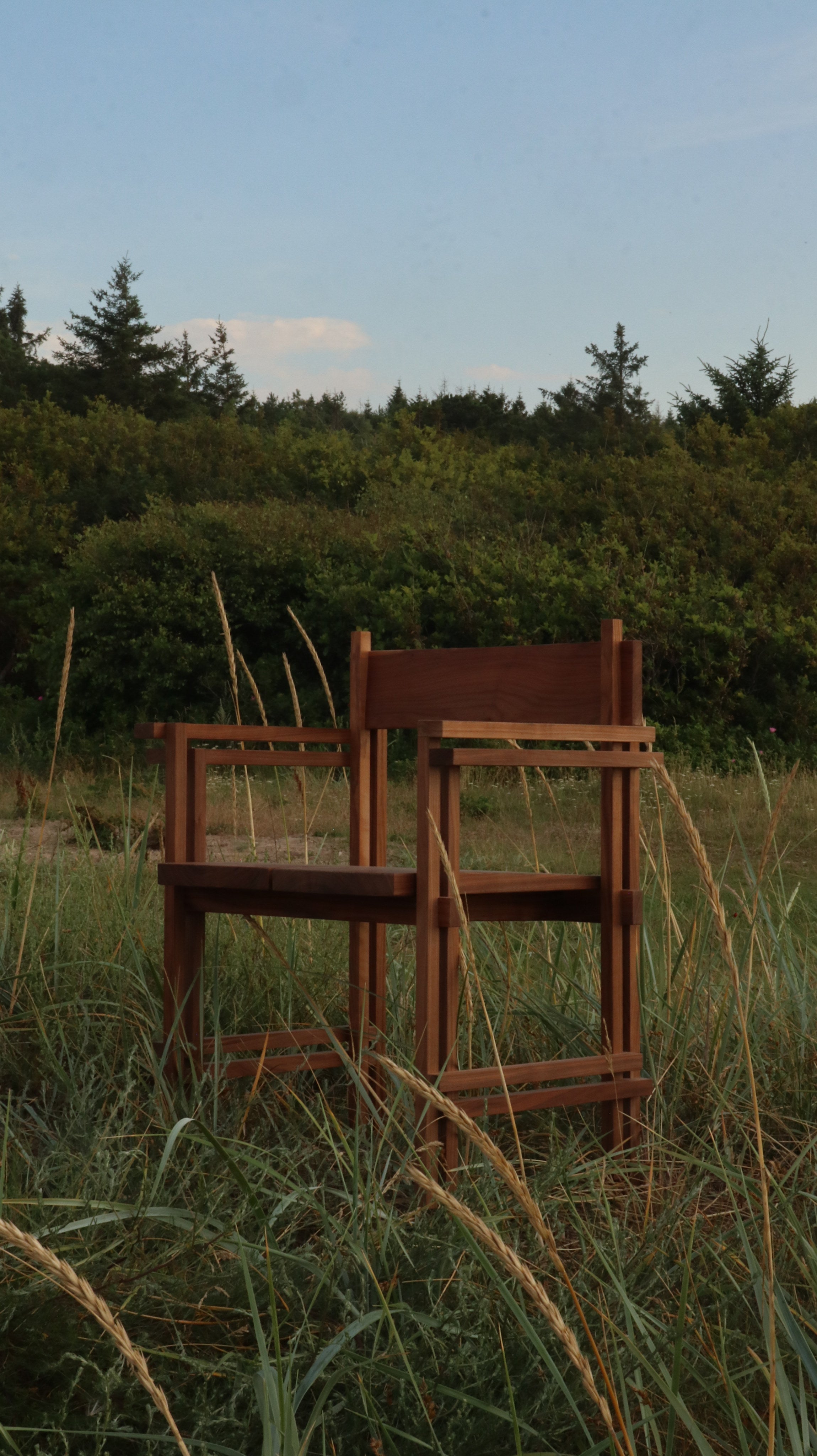 Stack chair with armrests — outdoor view in tall grass