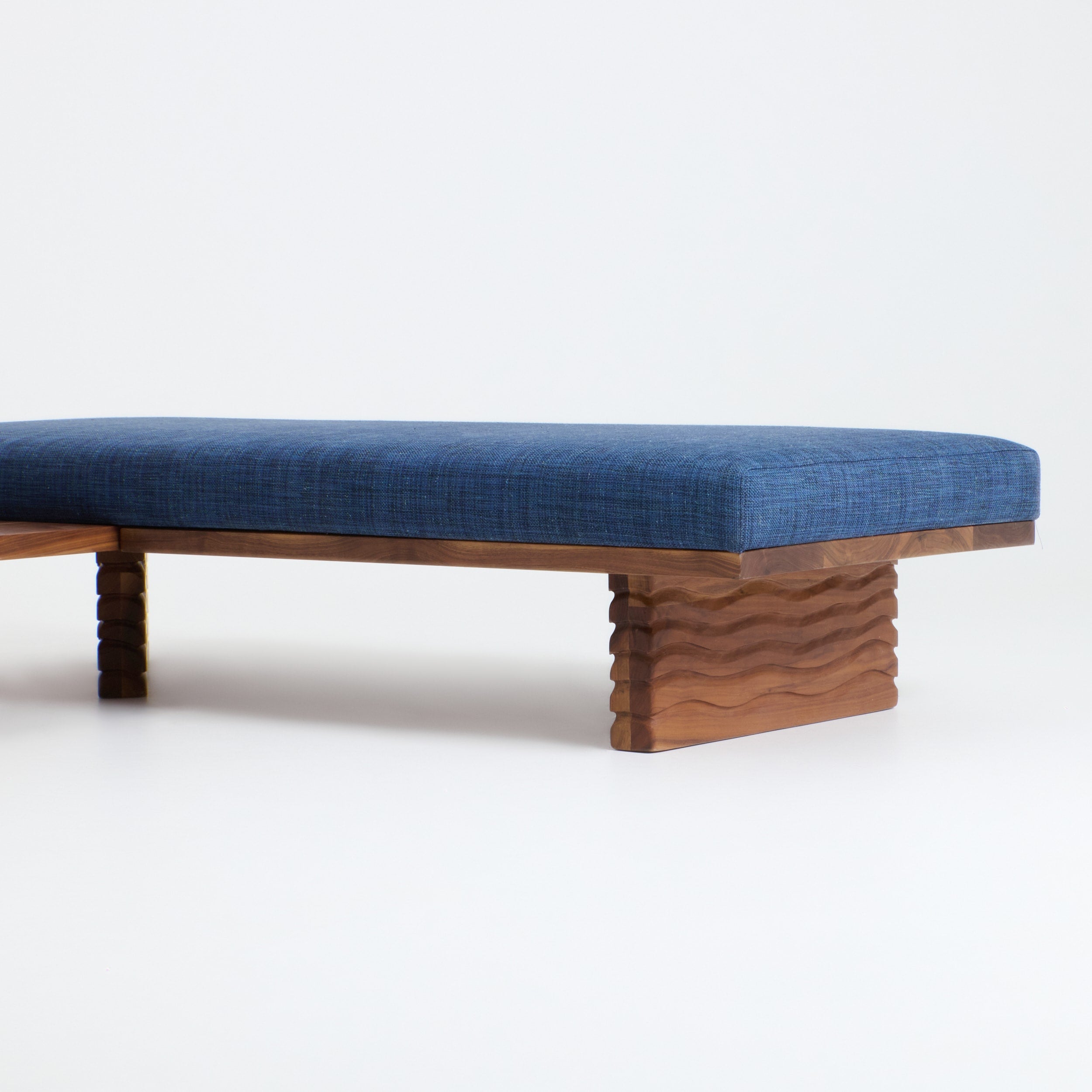 Nazaré Daybed L Shape — side view showing blue fabric and wooden base