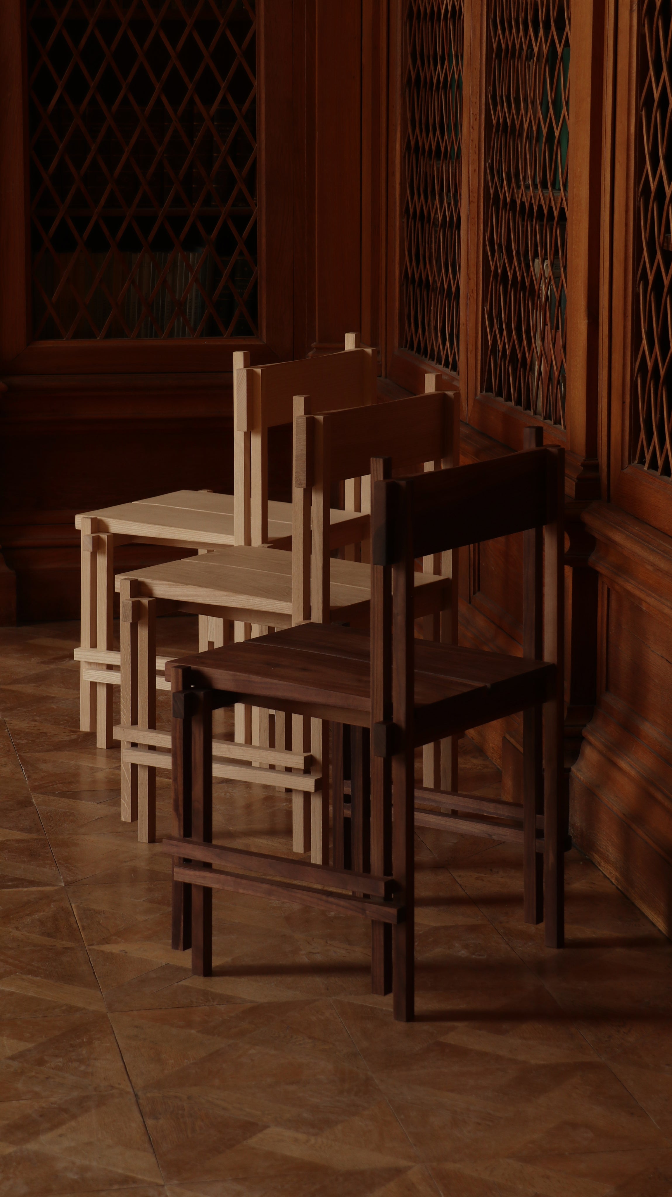 Stackable wooden chairs by Filippo Andrighetto in warm interior