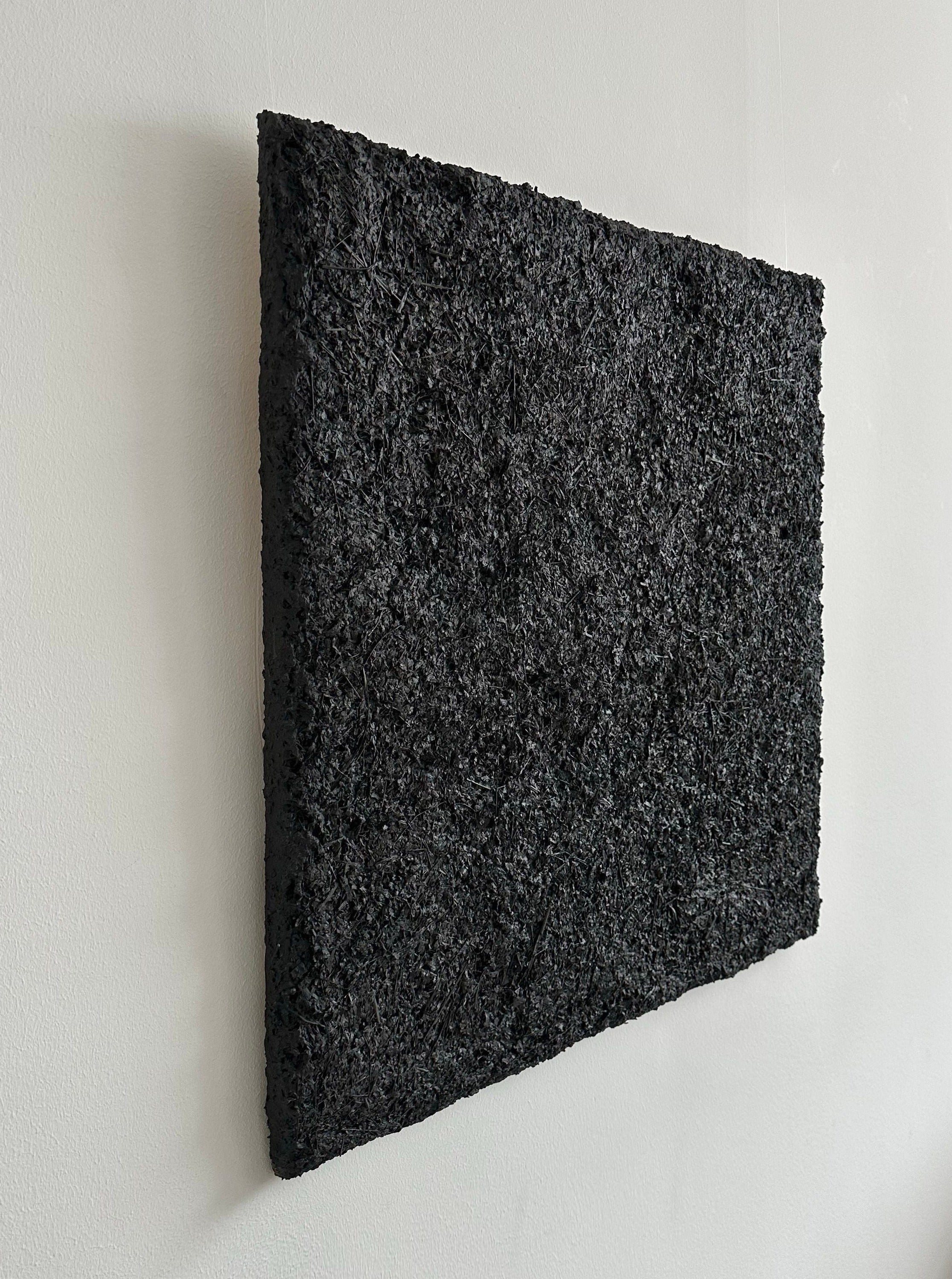 ARCHE 01' sculptural wall art — textured black surface on white wall