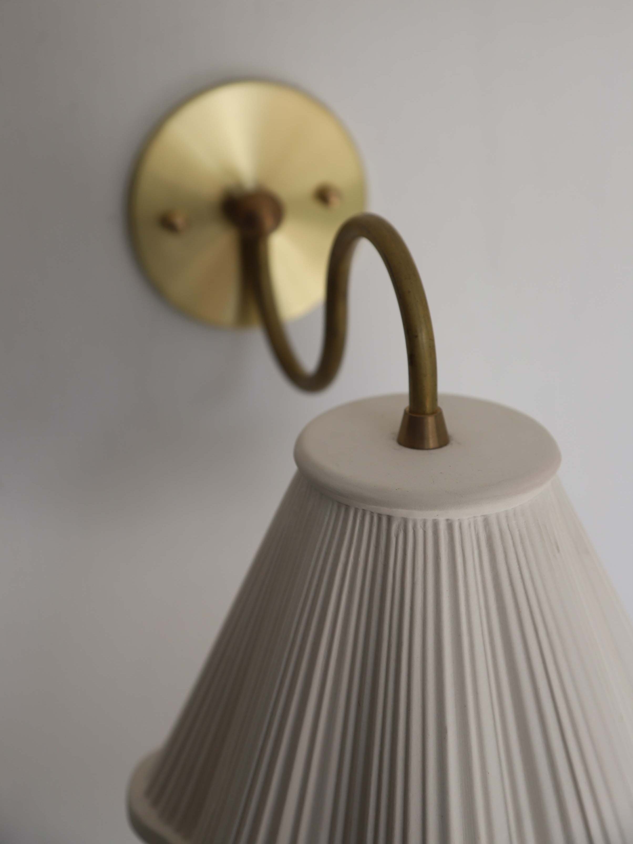 Lucy Sconce — top view of white pleated shade and brass arm
