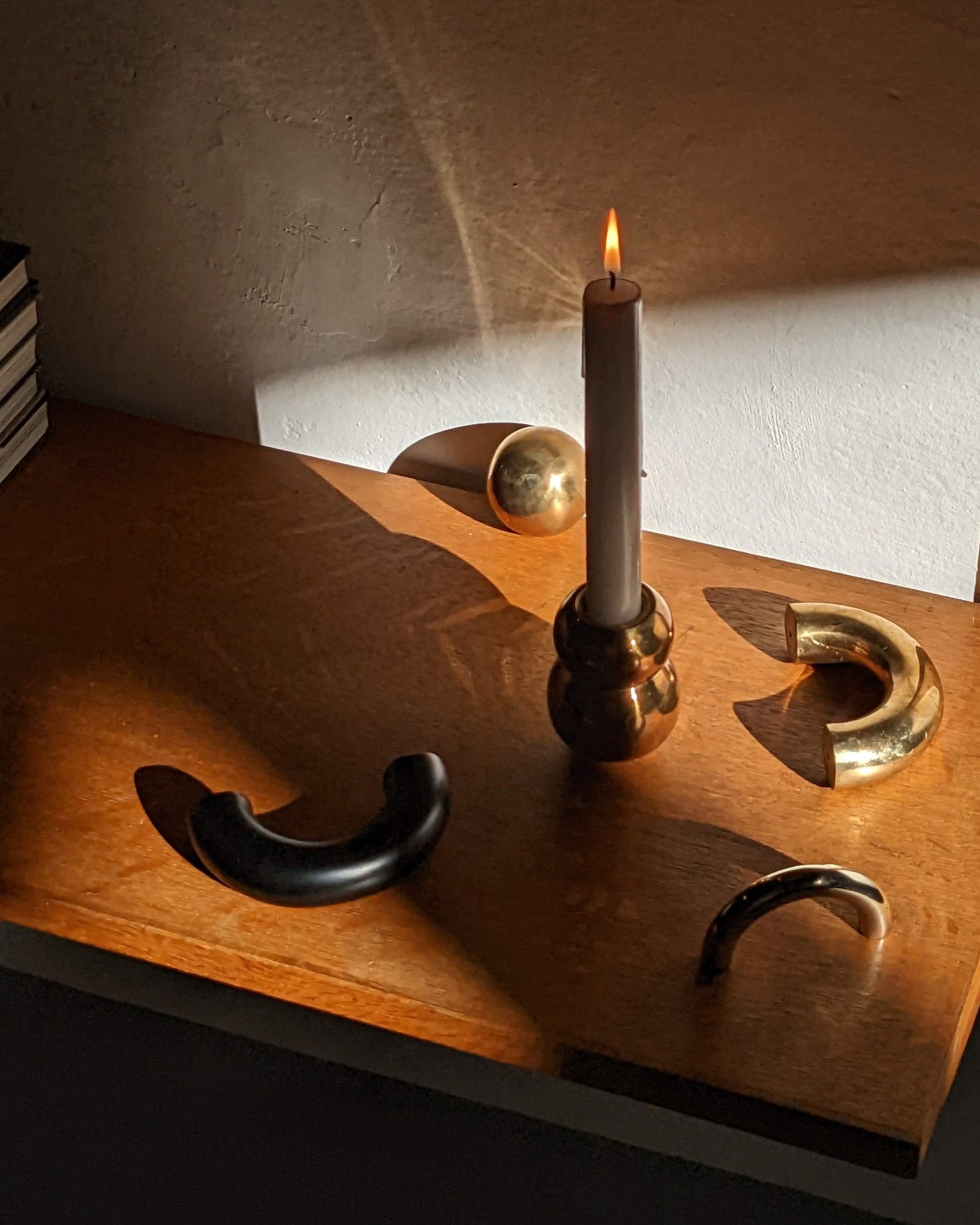 CERCLE Cabinet Pull Thick — arranged on wooden surface with candle