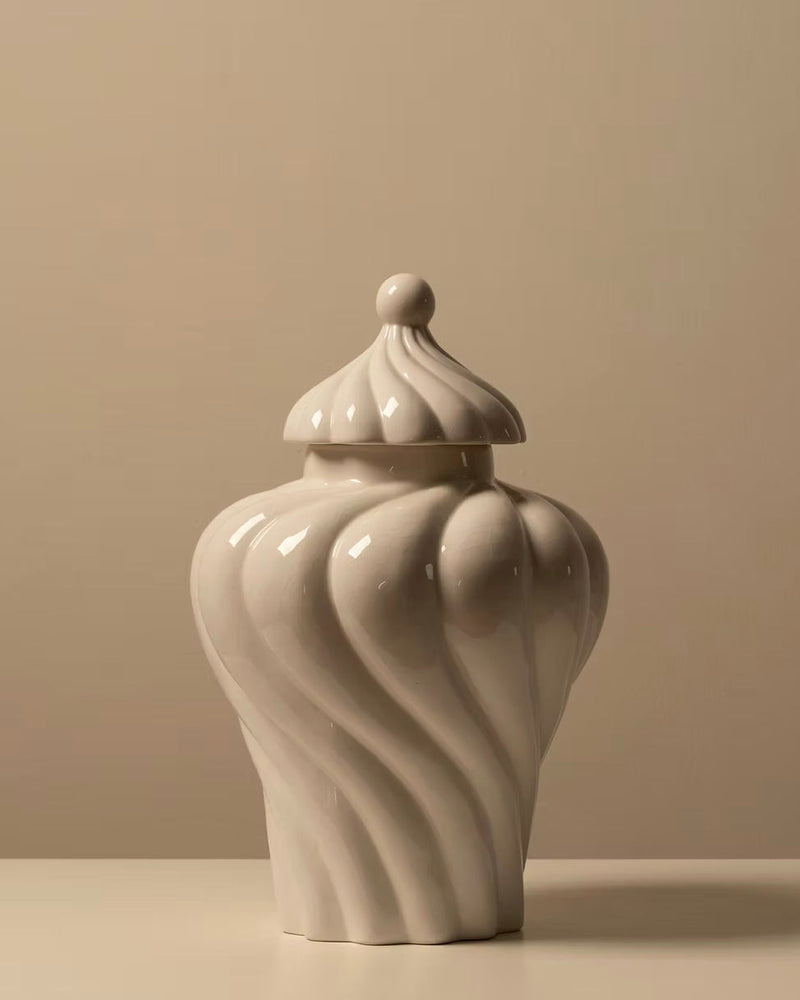 Ceramic jar with flowing spiral ridges and domed lid in cream glaze