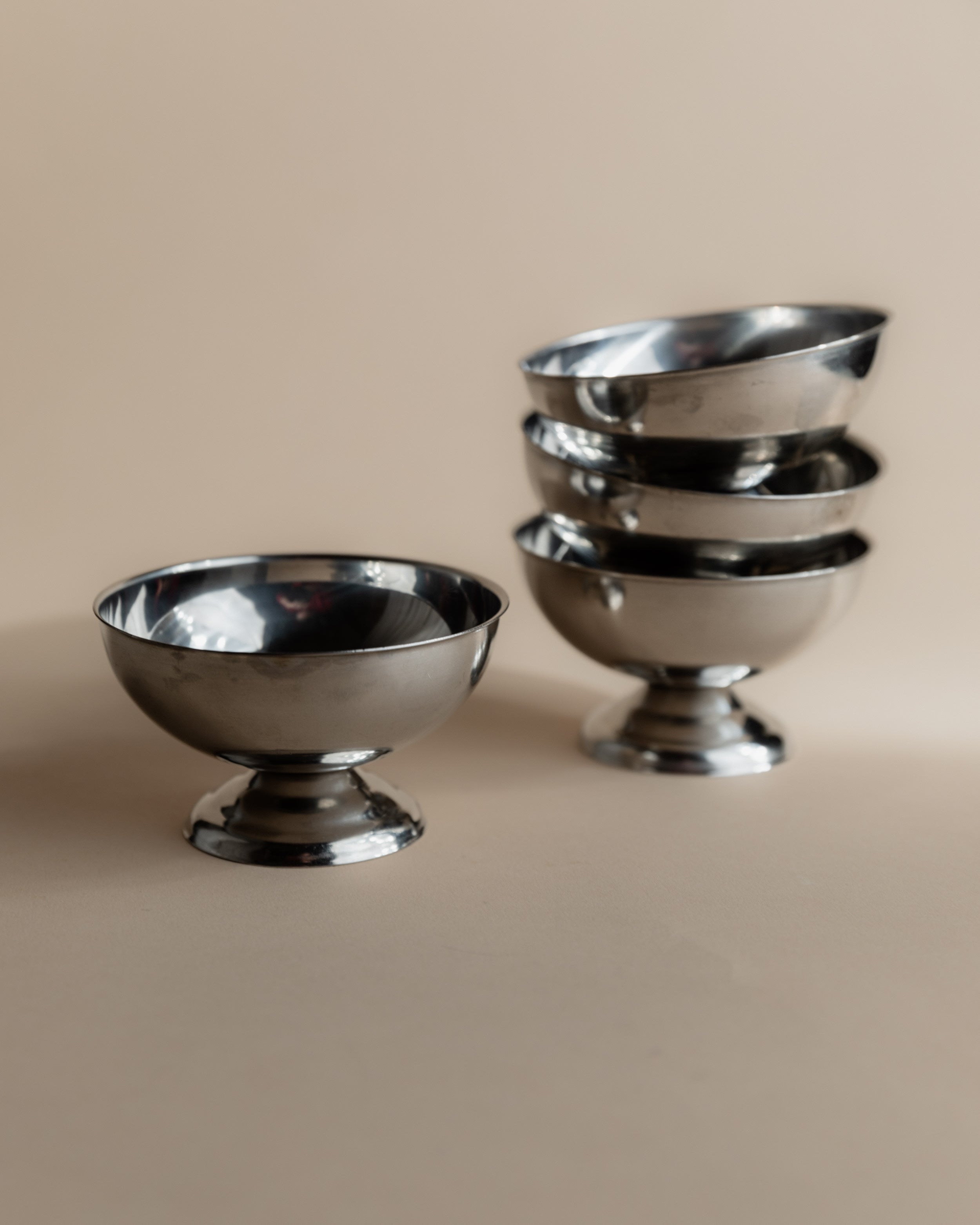 Vintage 1970s Ice Cream Serving Set for 4, Stainless Steel Cups — stacked cups on neutral background