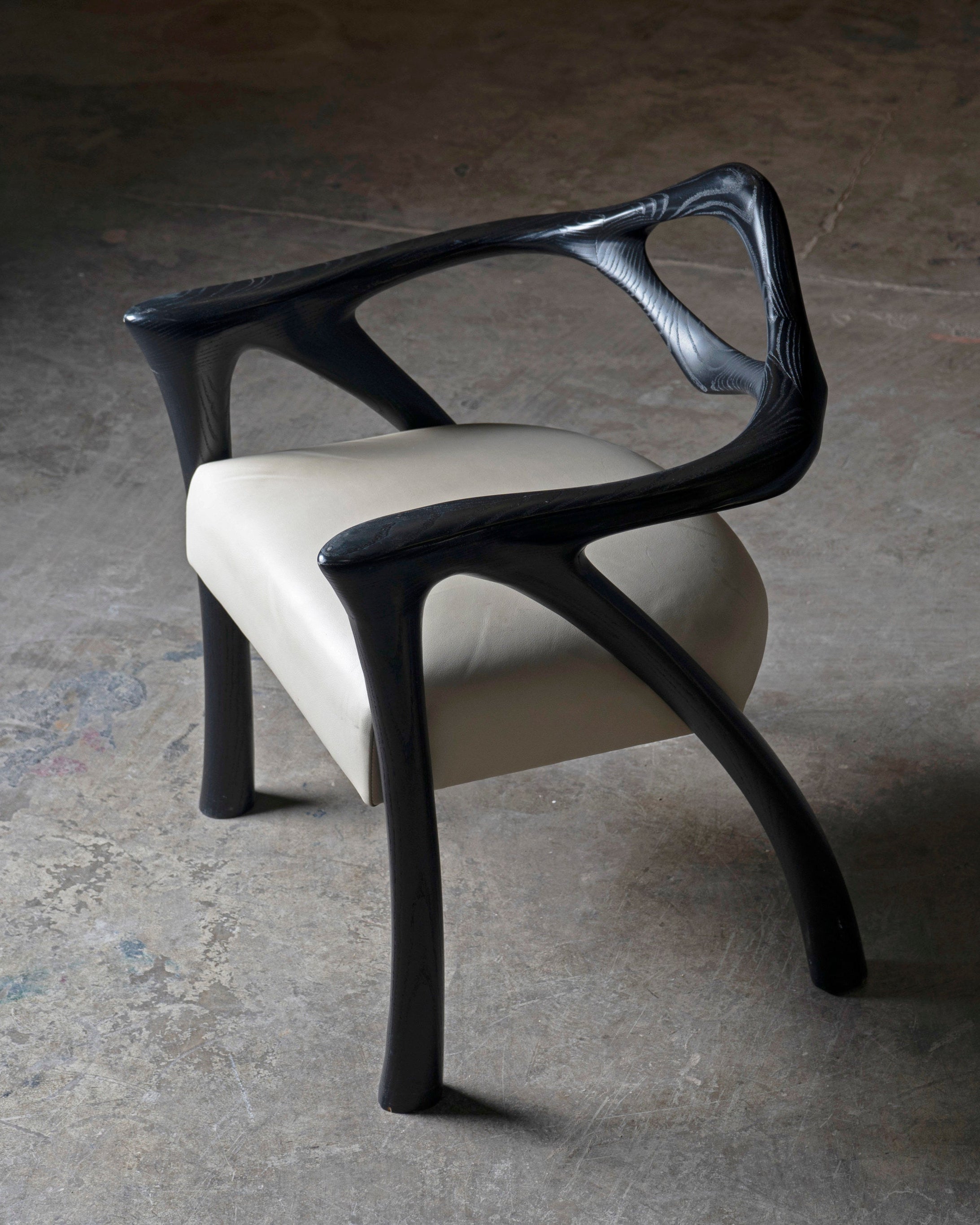 Darcey Armchair in Ash wood by Amorph — side angle showing curved arms and cream seat