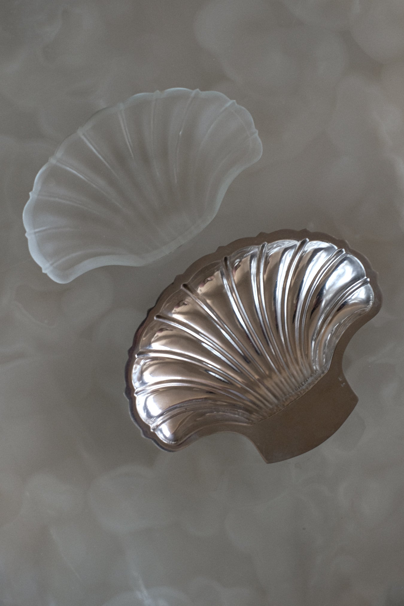 Shell Shaped Butter Dish — top view on textured surface