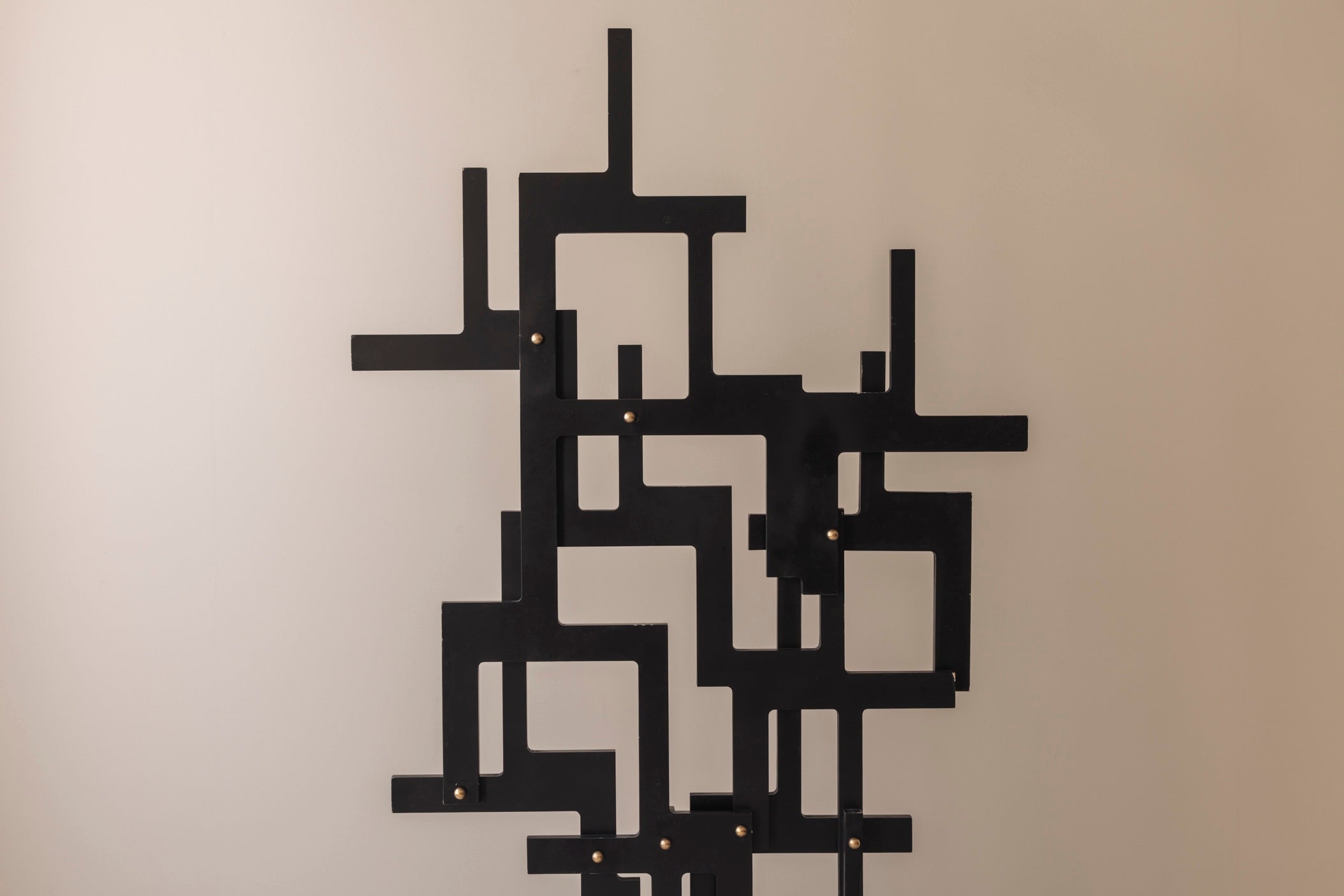 Large geometric abstract sculpture in lacquered wood and brass, France 1990s — lifestyle setting