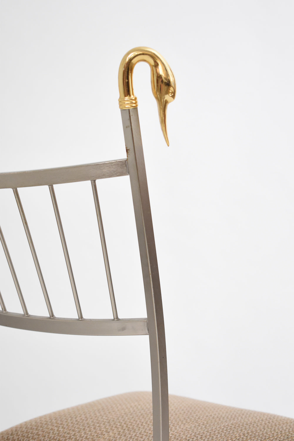 Pair of Swan Chairs — close-up of gold swan head detail