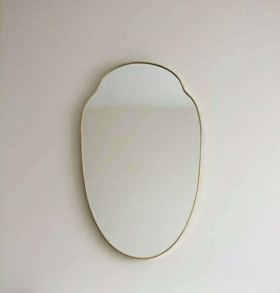 Large Mid-Century Italian Brass Shield Mirror by Maud Vaughan | The Oblist — brass frame, reflective surface