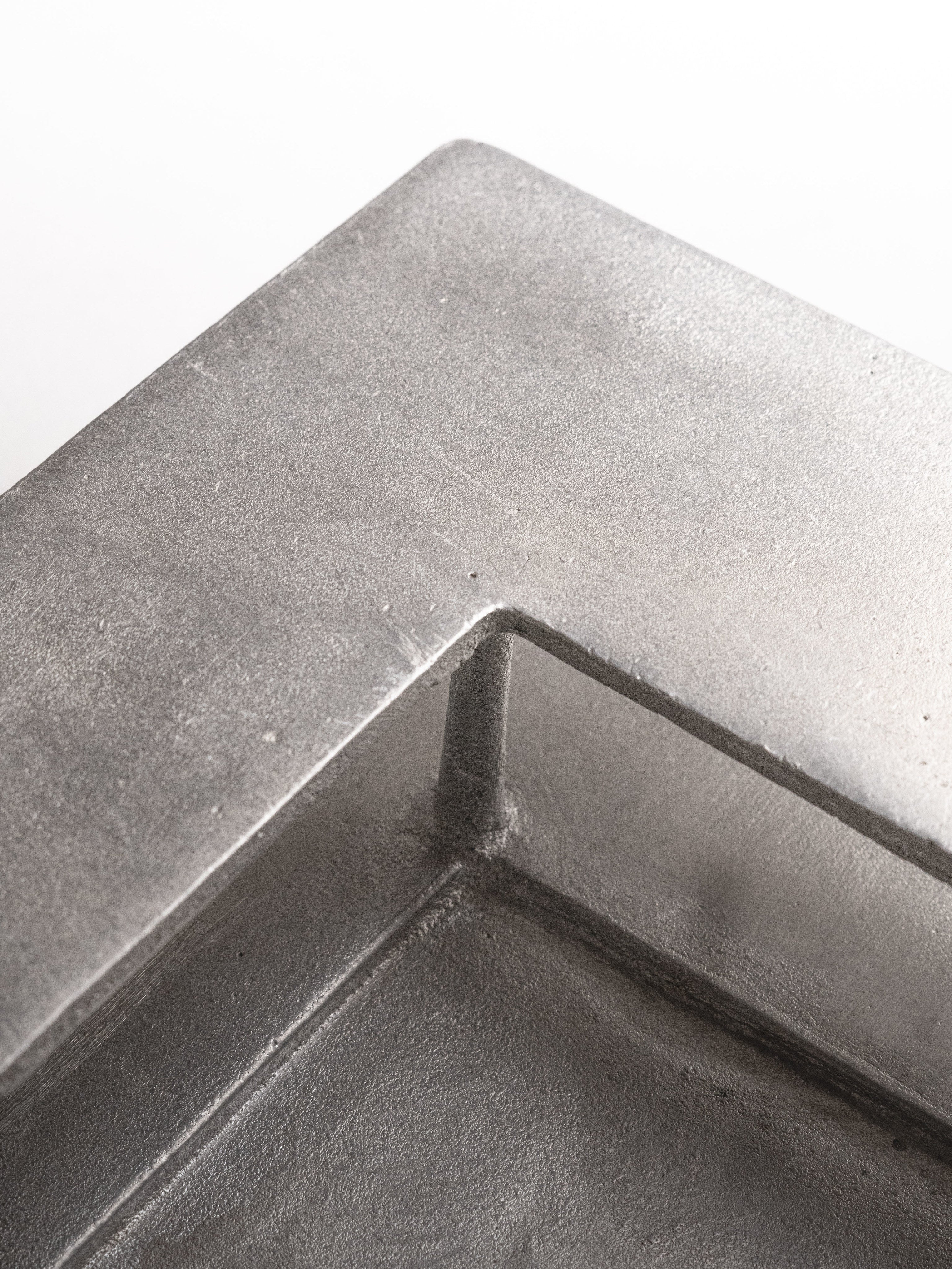 The Courtyard — close-up of brushed metal corner detail