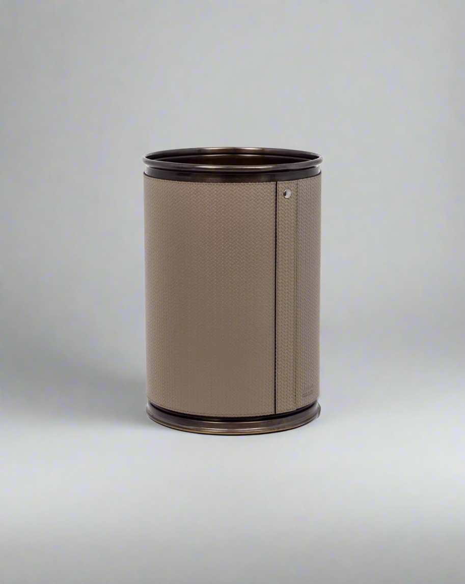 A cylindrical beige-colored Pinetti Round Metal Bin against a white background.