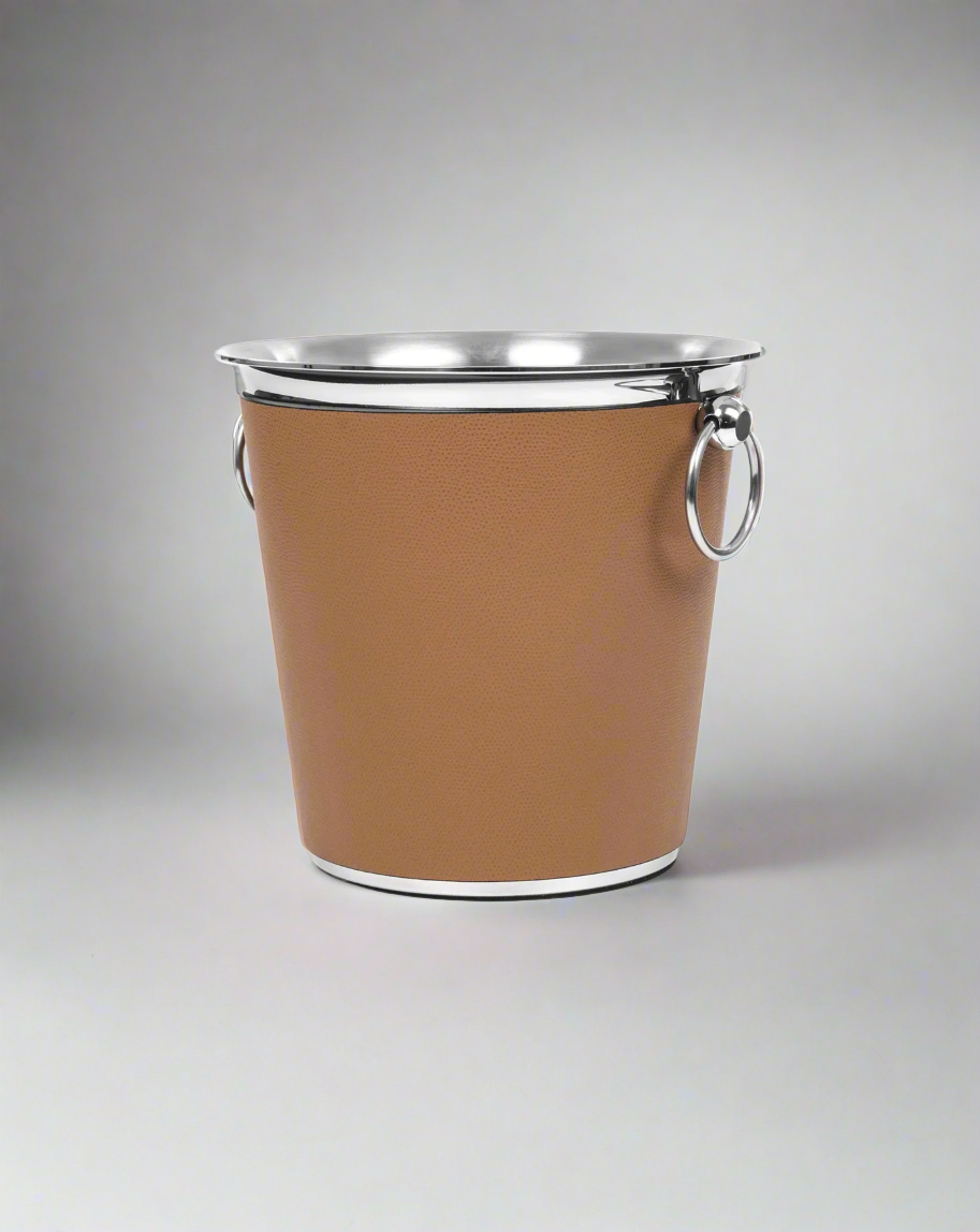 Elegant Pinetti champagne bucket encased in brown leather with stainless steel rim and handles, isolated on a white background.