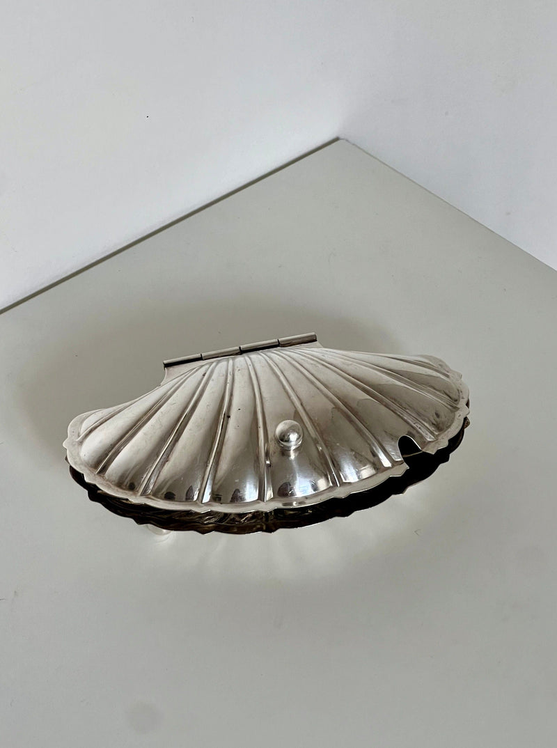 Silver shell-shaped decorative dish with ribbed surface and hinged lid