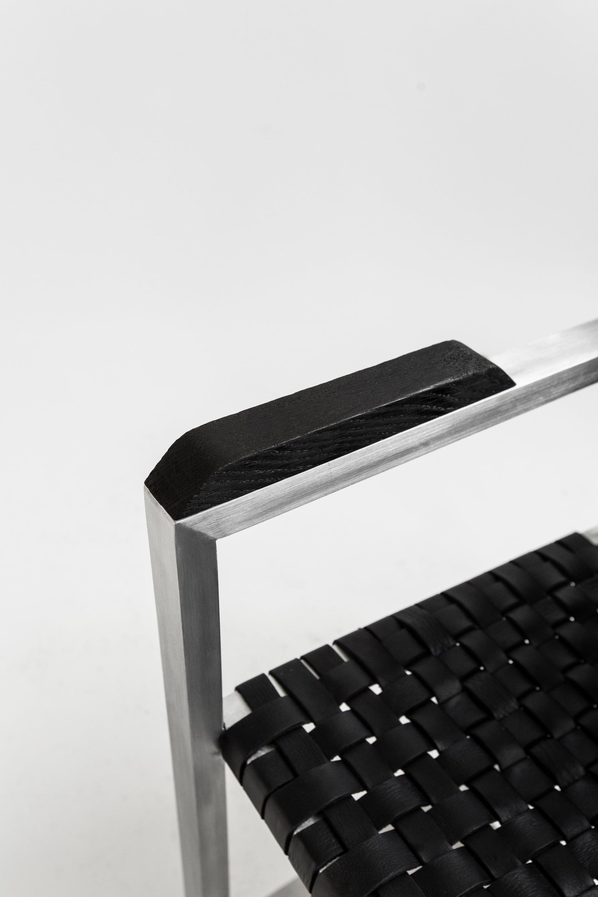 RIA II Lounge Chair — back view highlighting black woven seat and metal frame